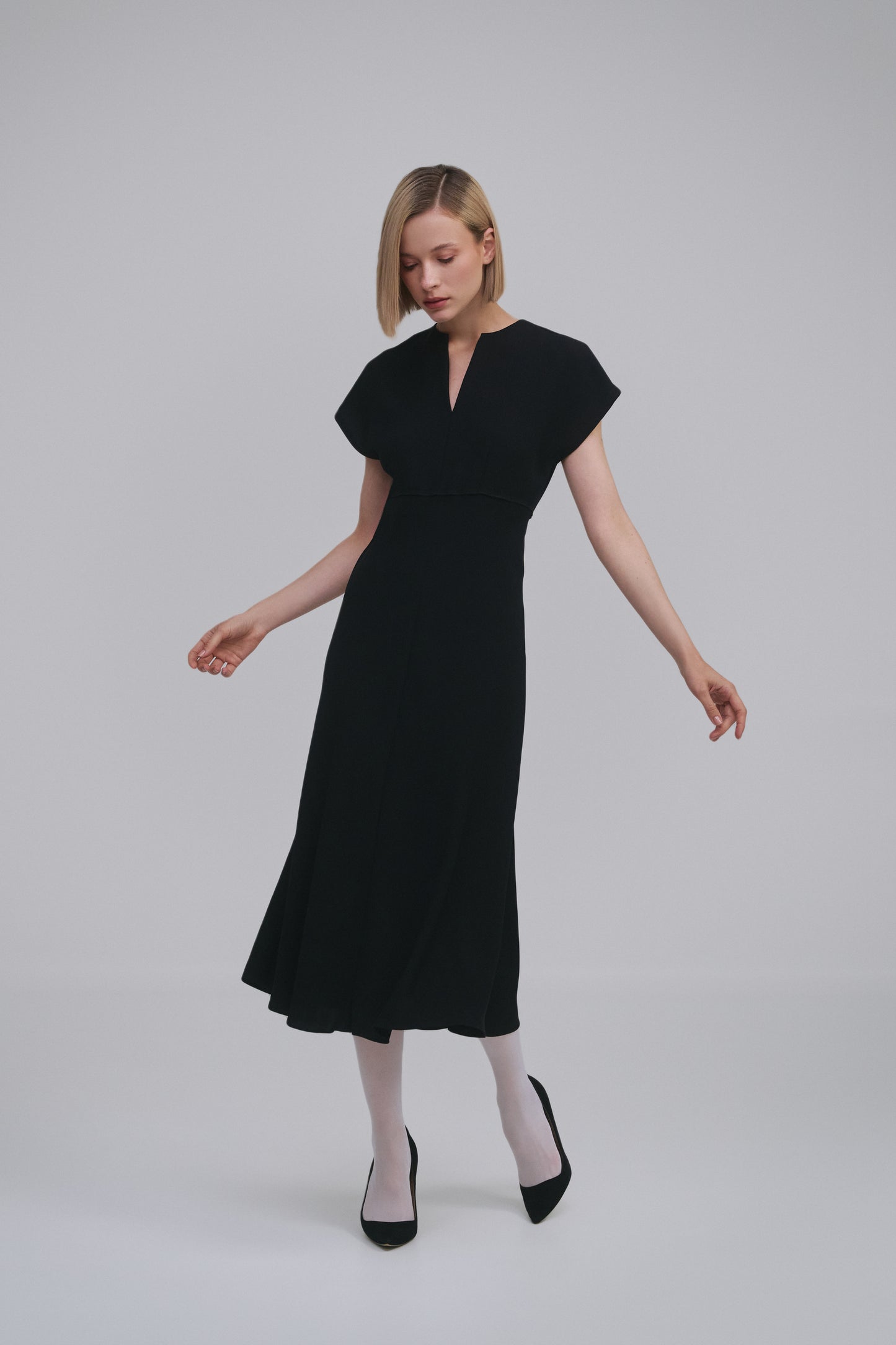 Model wears the Amelia Toro Bias-Cut Kimono-Sleeve Midi Dress in Black, front view