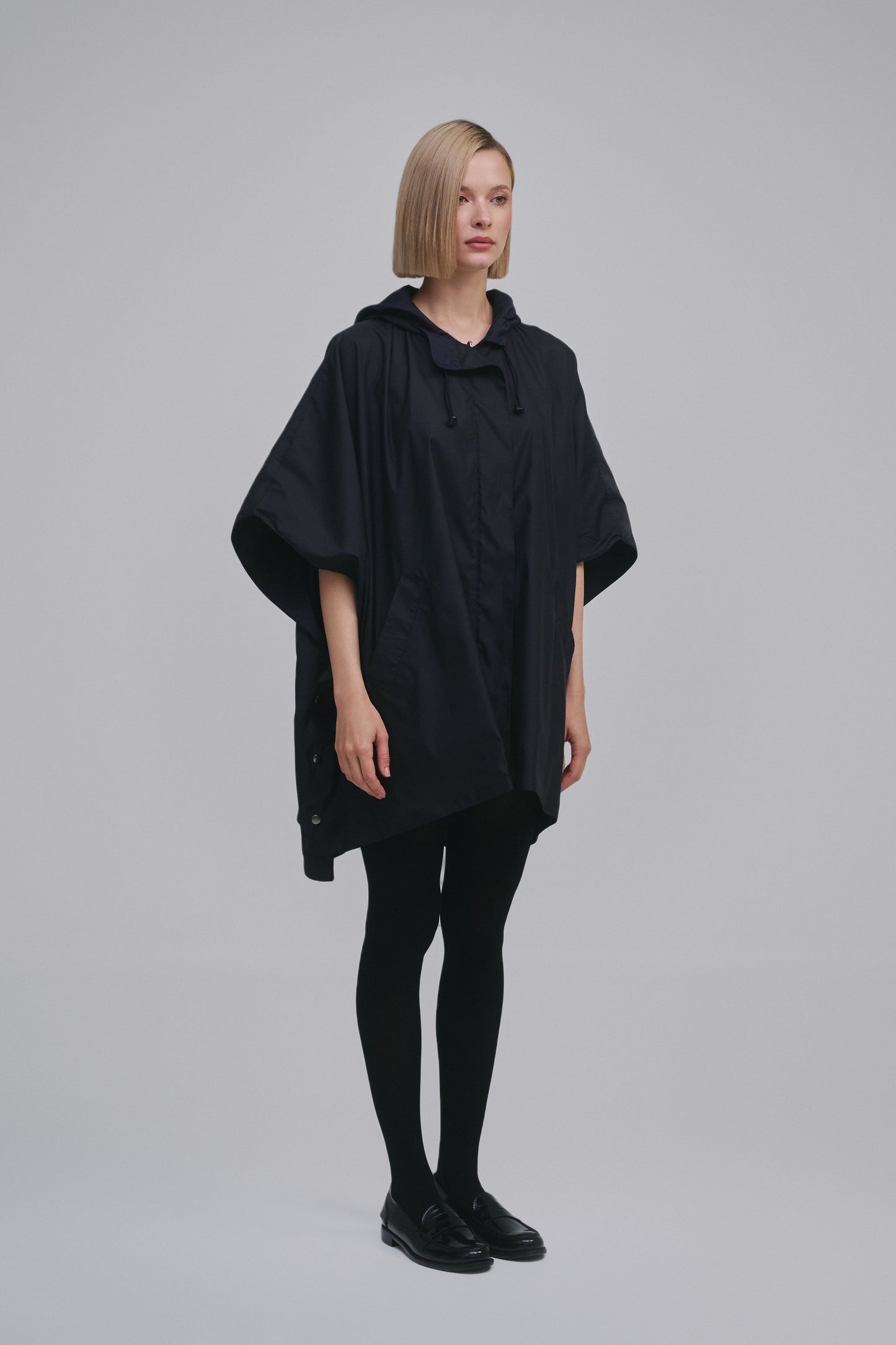 Side view of the Amelia Toro Water-Repellent Hooded Poncho in Black