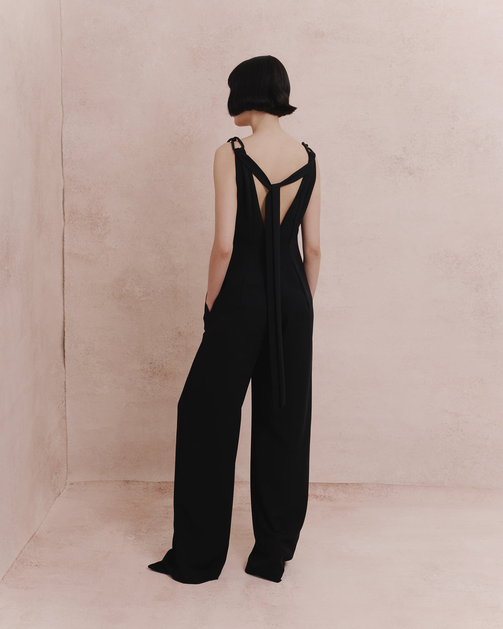 Model wears the Amelia Toro 1920s-Inspired Jumpsuit in black, front view