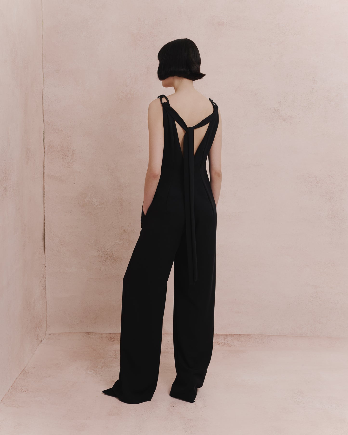 Model wears the Amelia Toro 1920s-Inspired Jumpsuit in black, front view