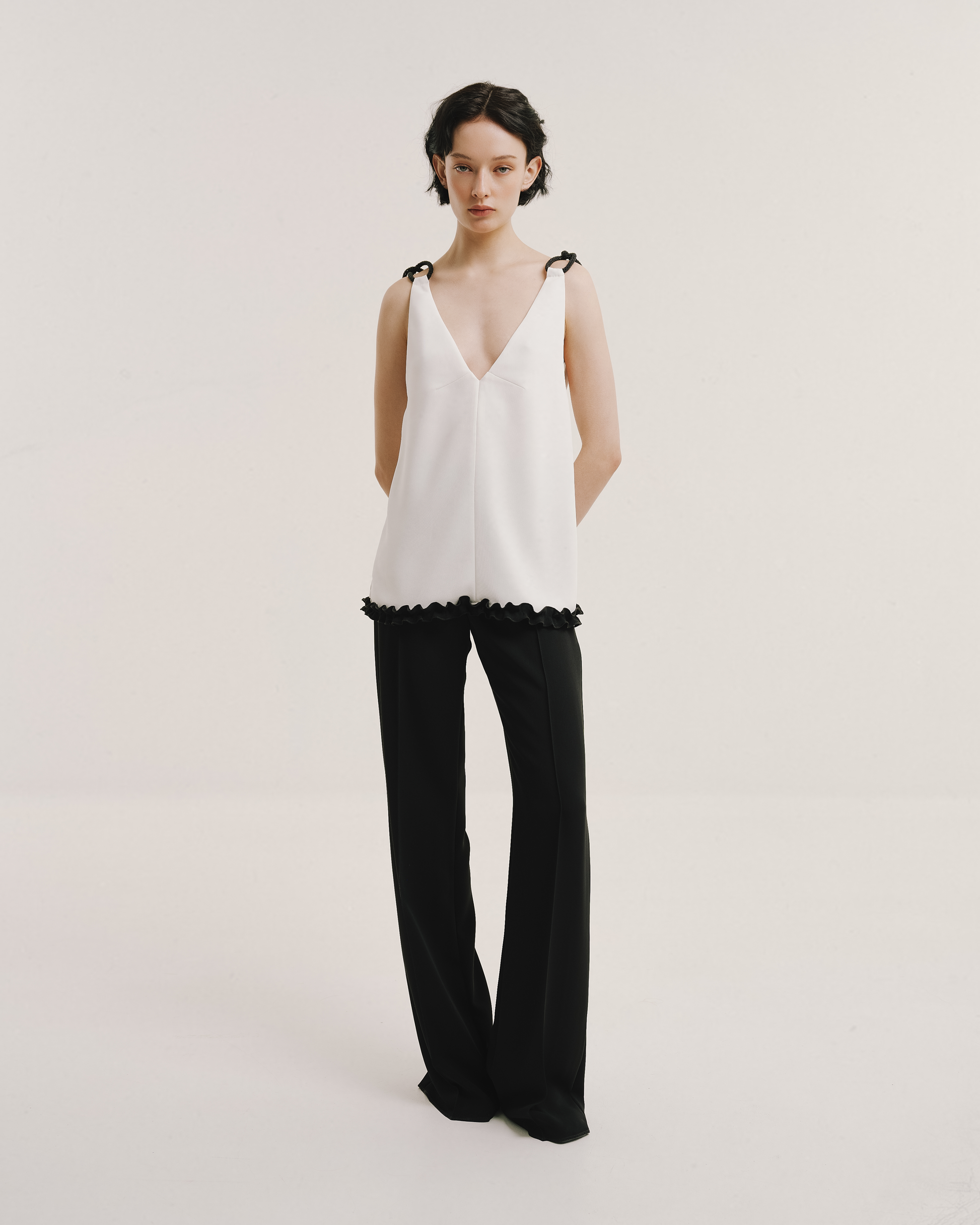 Model wears the Amelia Toro 1920s-Inspired Sleeveless Top in white, front view