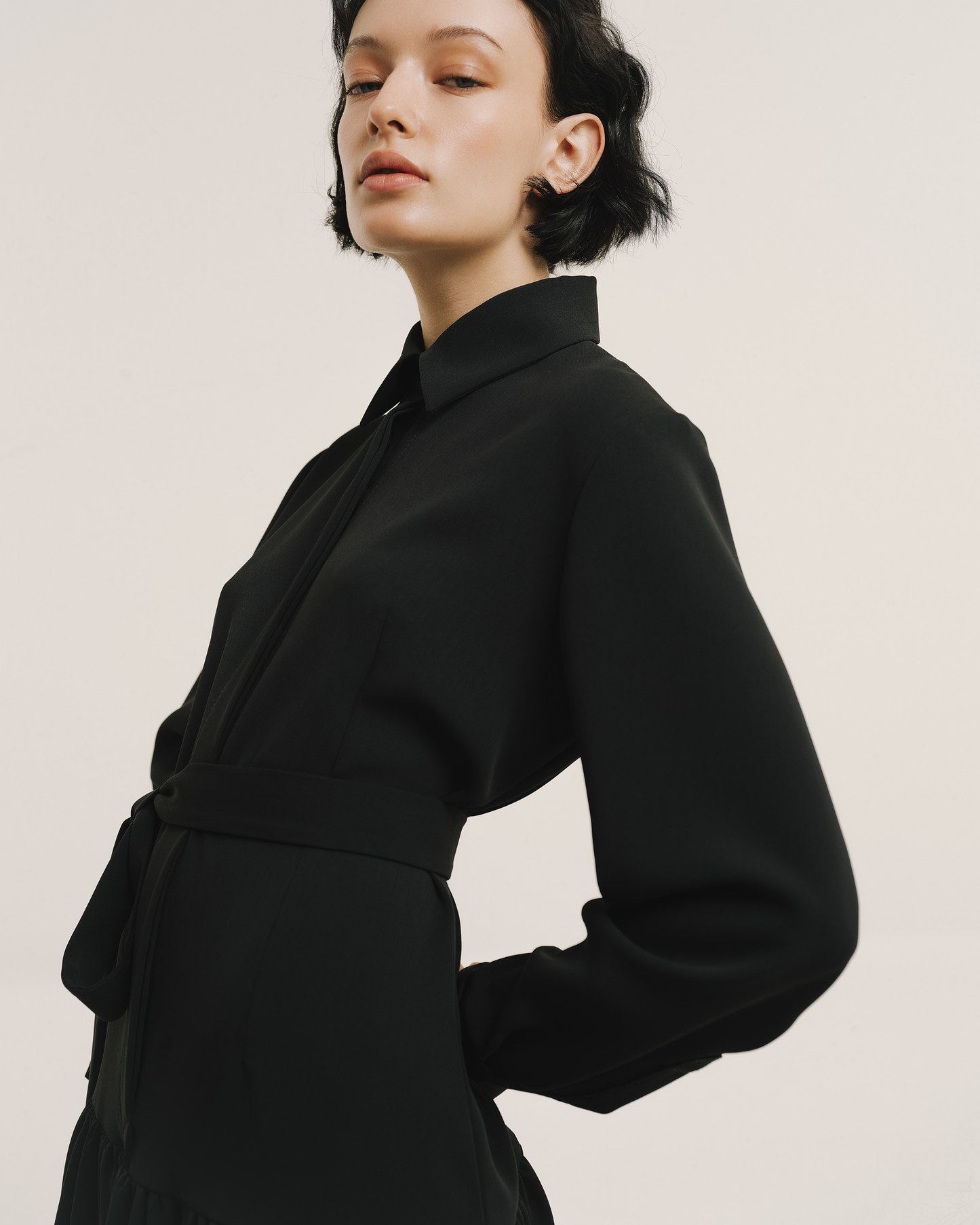 Model wears the Amelia Toro Belted Shirt Dress in black, front view