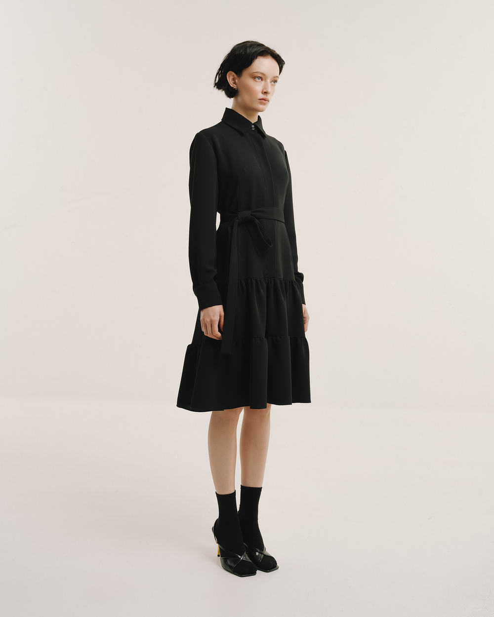 Model wears the Amelia Toro Belted Shirt Dress in black, front view