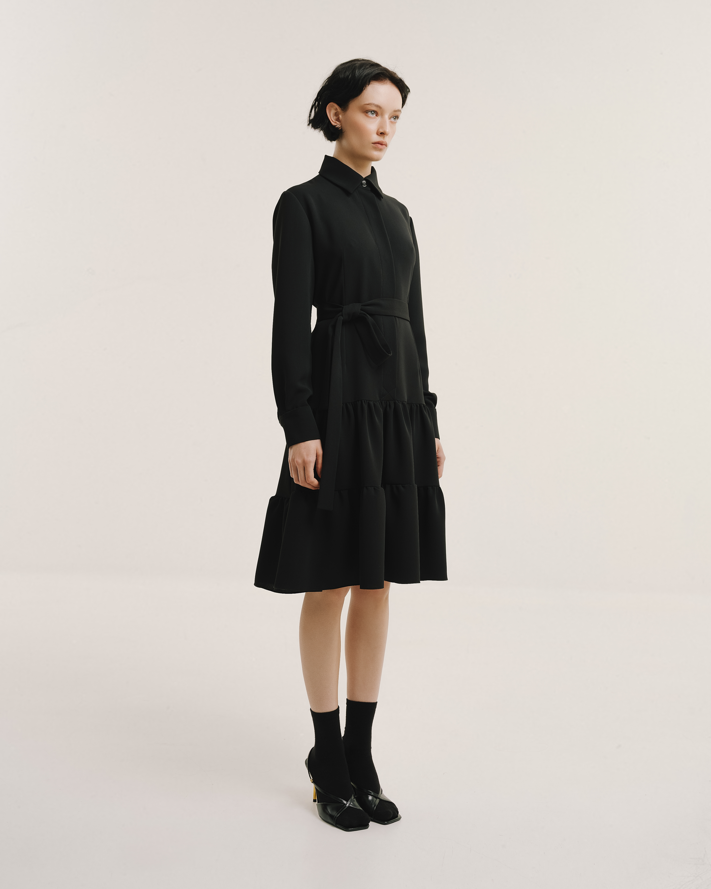 Model wears the Amelia Toro Belted Shirt Dress in black, front view