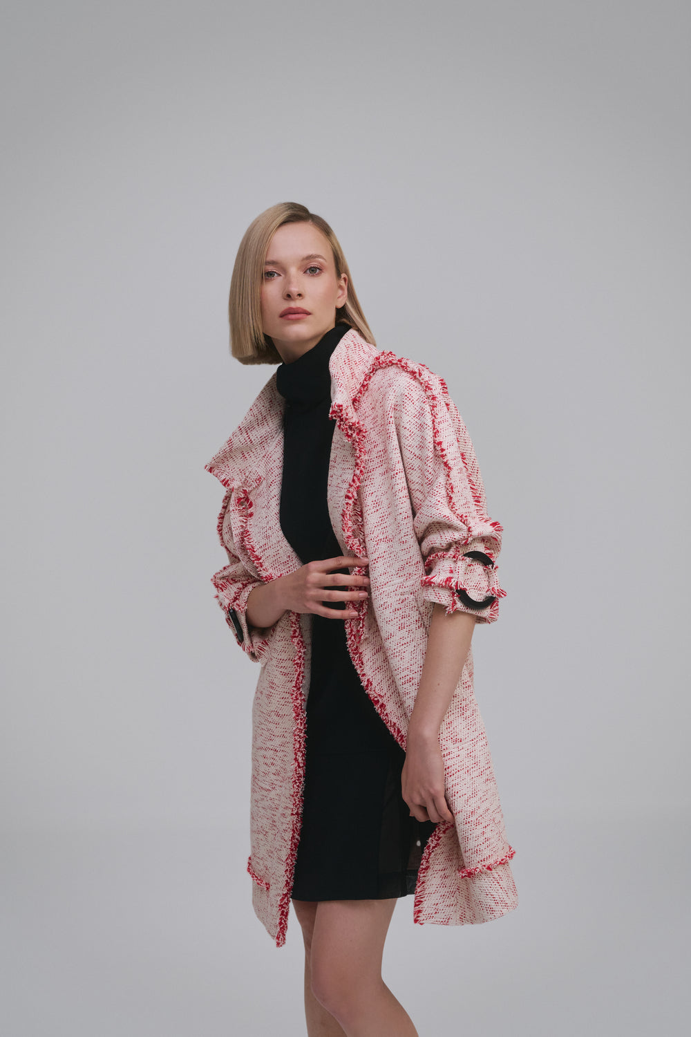 Model wears the Amelia Toro Compact Cotton Coat with Fringe Detail in Red/Beige, front view