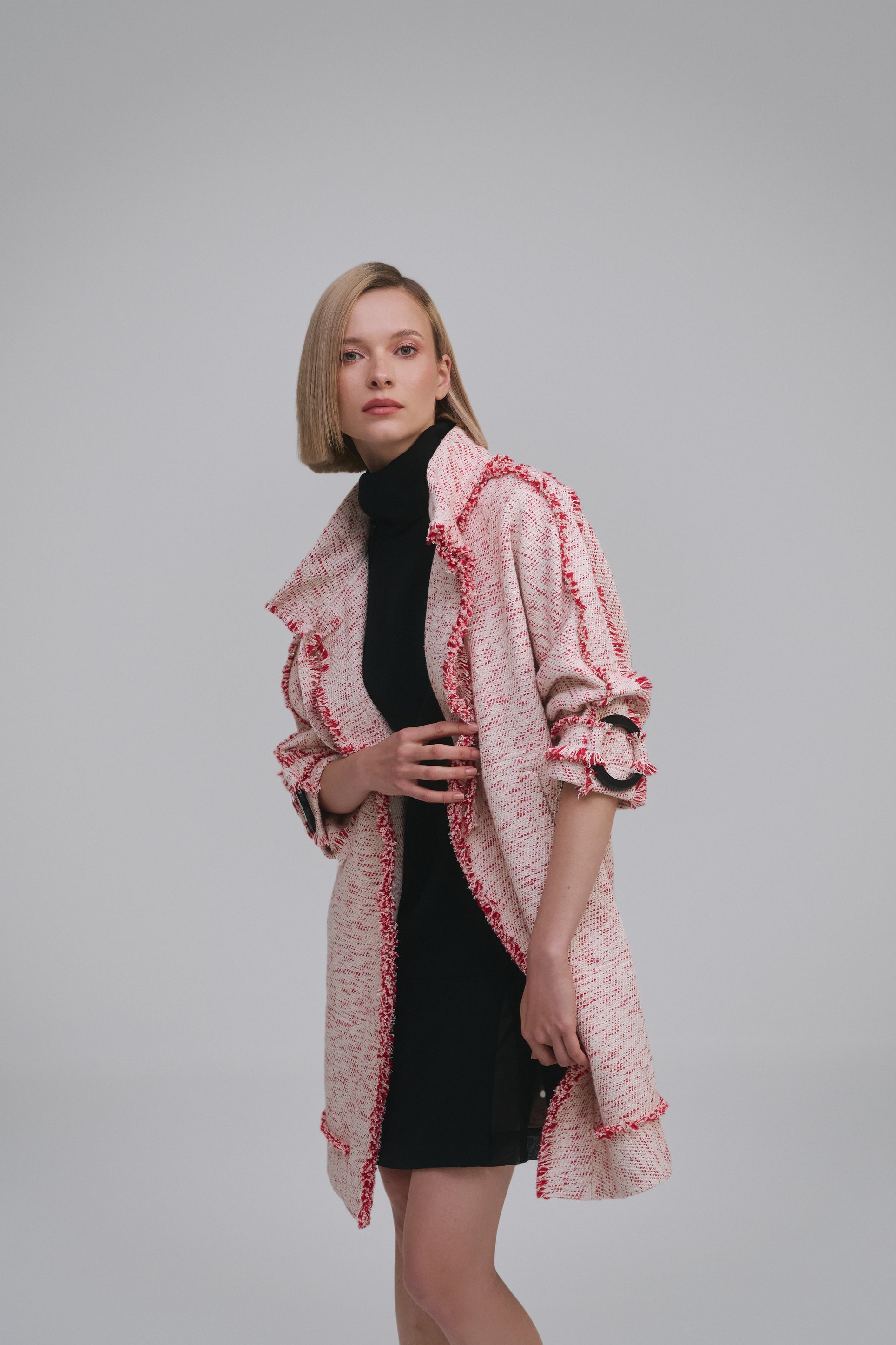 Model wears the Amelia Toro Compact Cotton Coat with Fringe Detail in Red/Beige, front view