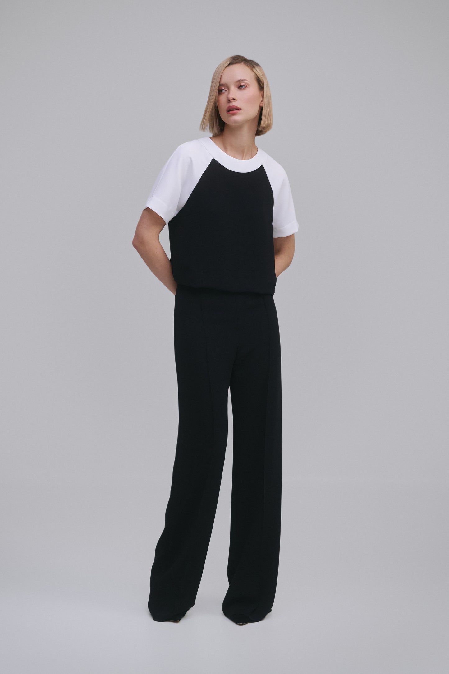 Model wears the Amelia Toro Contrast Raglan-Sleeve Top in Black & White, front view