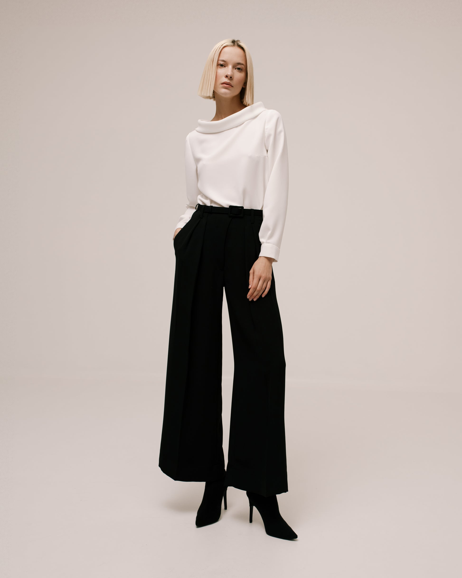 Model wears the Amelia Toro Crop Wide-Leg Pleated Cady Trousers in Black, front view