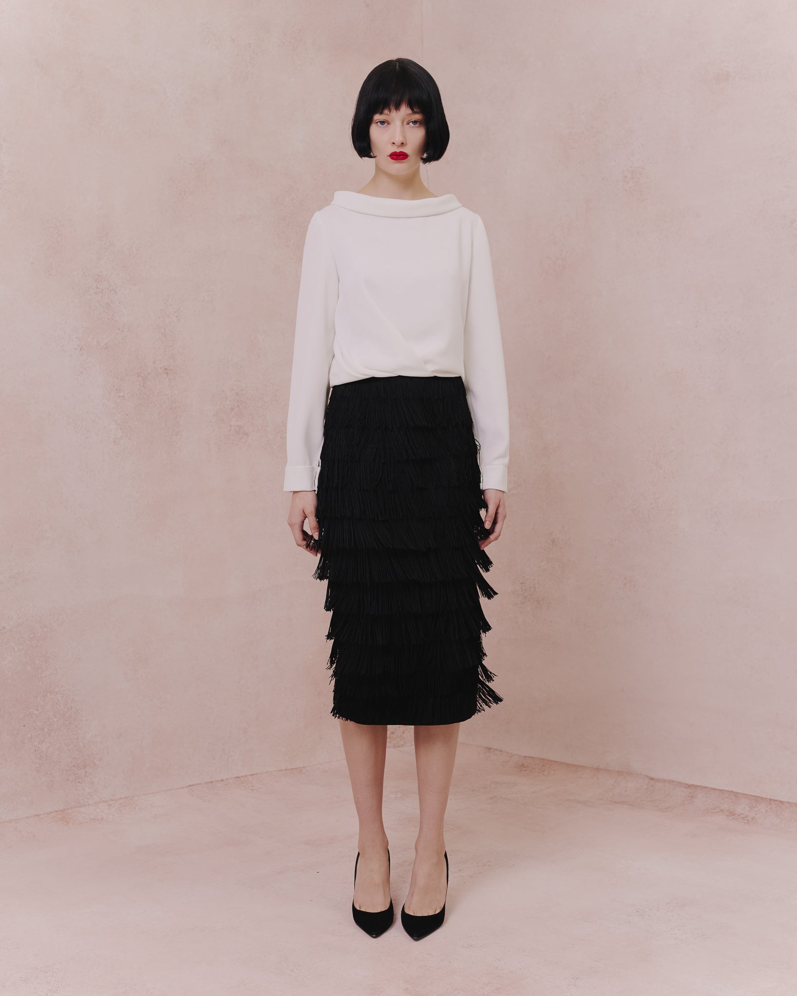 Model wears the Amelia Toro Draped-Waist Long-Sleeve Blouse in white, front view