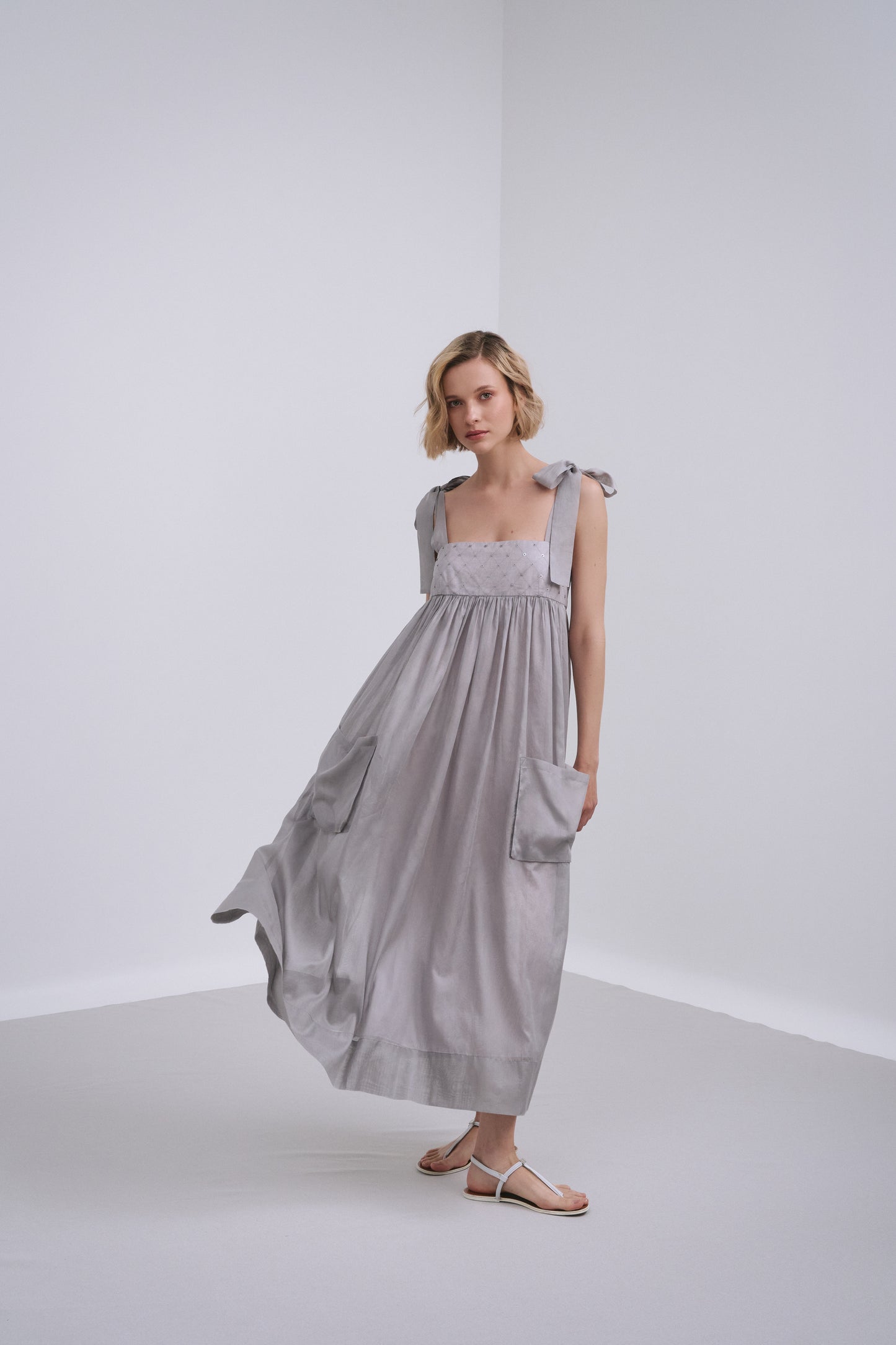 Model wears the Amelia Toro Embroidered Cotton Voile Midi Sundress in Graphite/Grey, front view