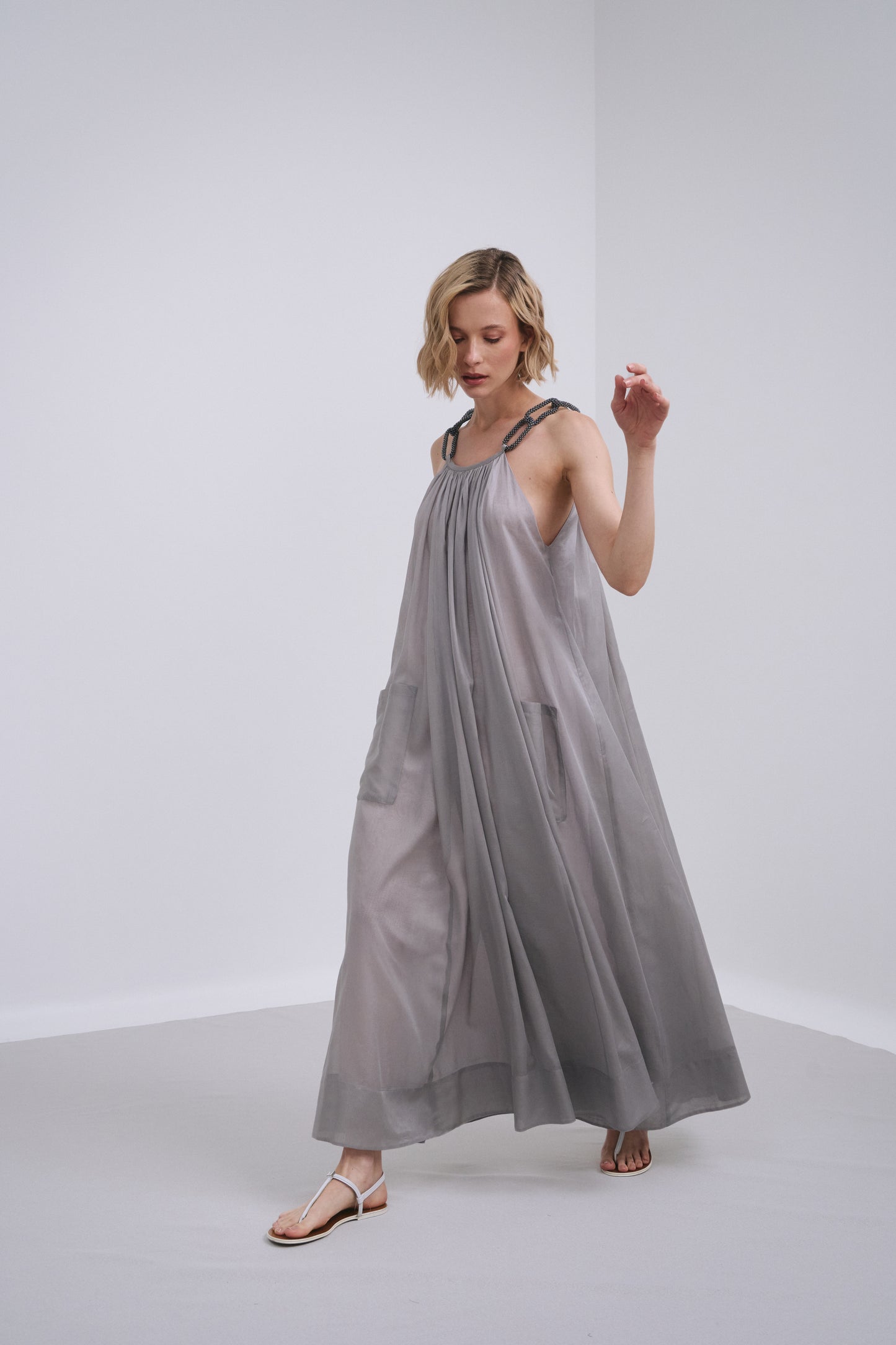 Model wears the Amelia Toro Embroidered Halter Cotton Voile Midi Dress in Grey/Pink, front view