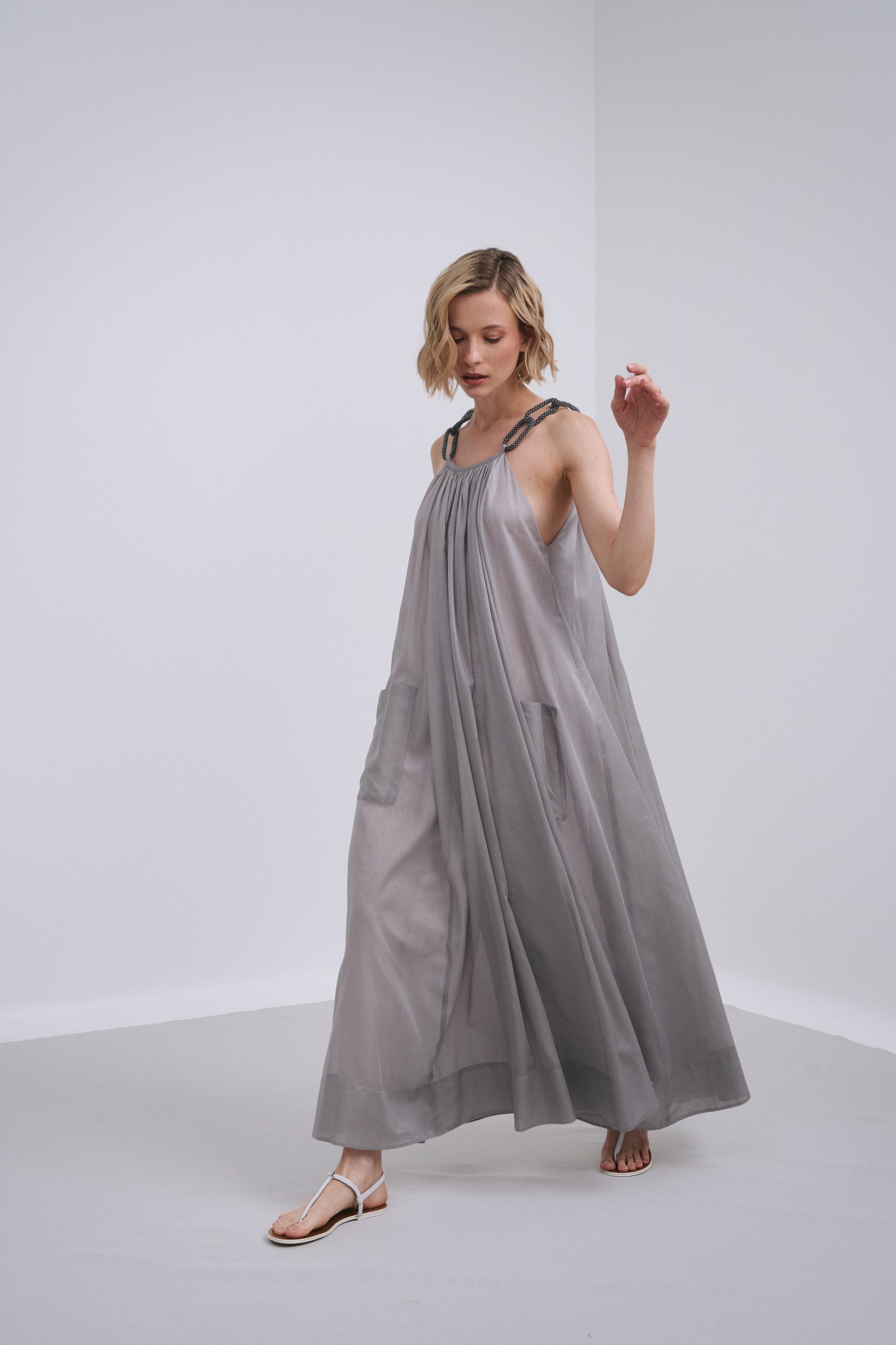 Model wears the Amelia Toro Embroidered Halter Cotton Voile Midi Dress in Grey/Pink, front view