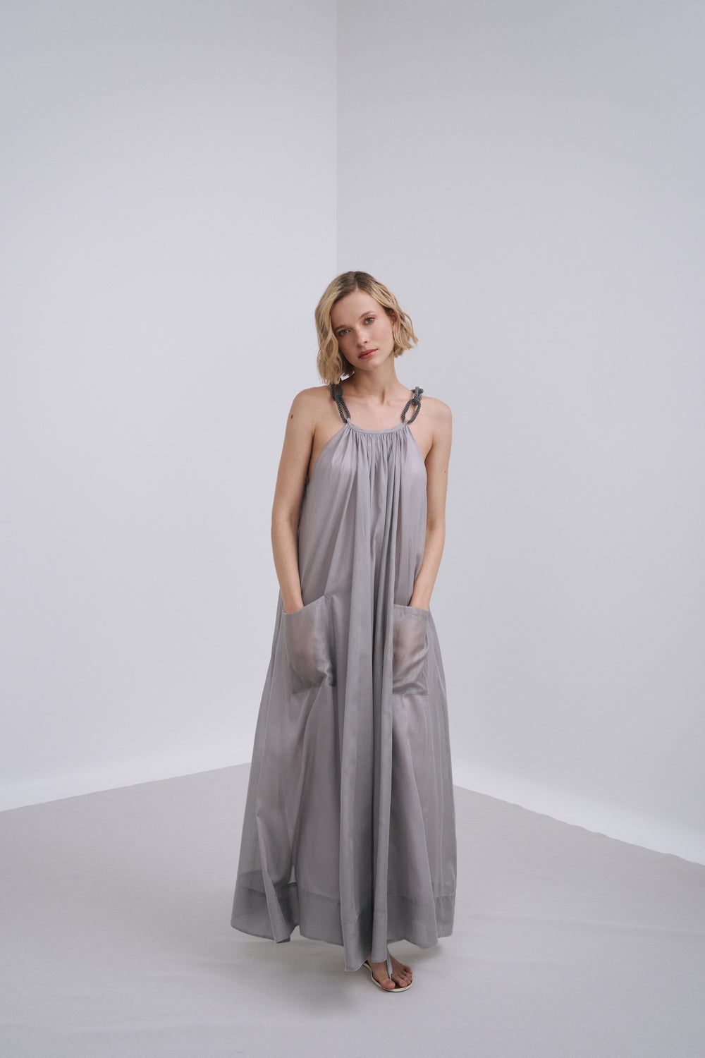 Model wears the Amelia Toro Embroidered Halter Cotton Voile Midi Dress in Grey/Pink, front view