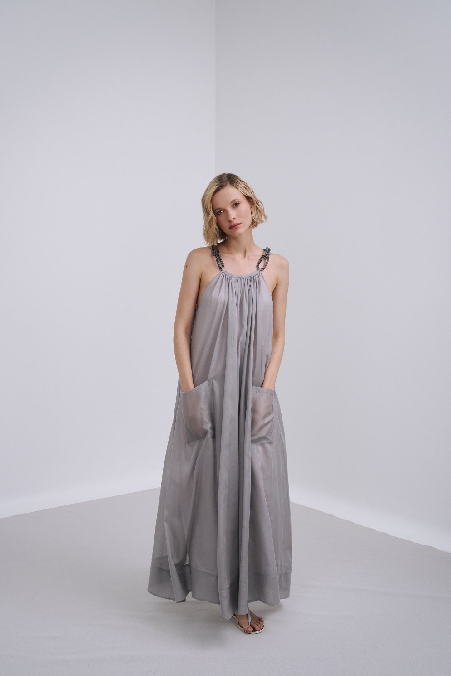 Model wears the Amelia Toro Embroidered Halter Cotton Voile Midi Dress in Grey/Pink, front view