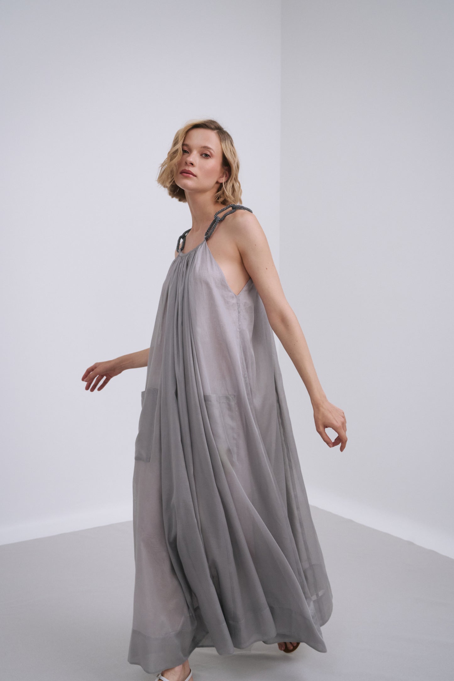 Model wears the Amelia Toro Embroidered Halter Cotton Voile Midi Dress in Red, front view