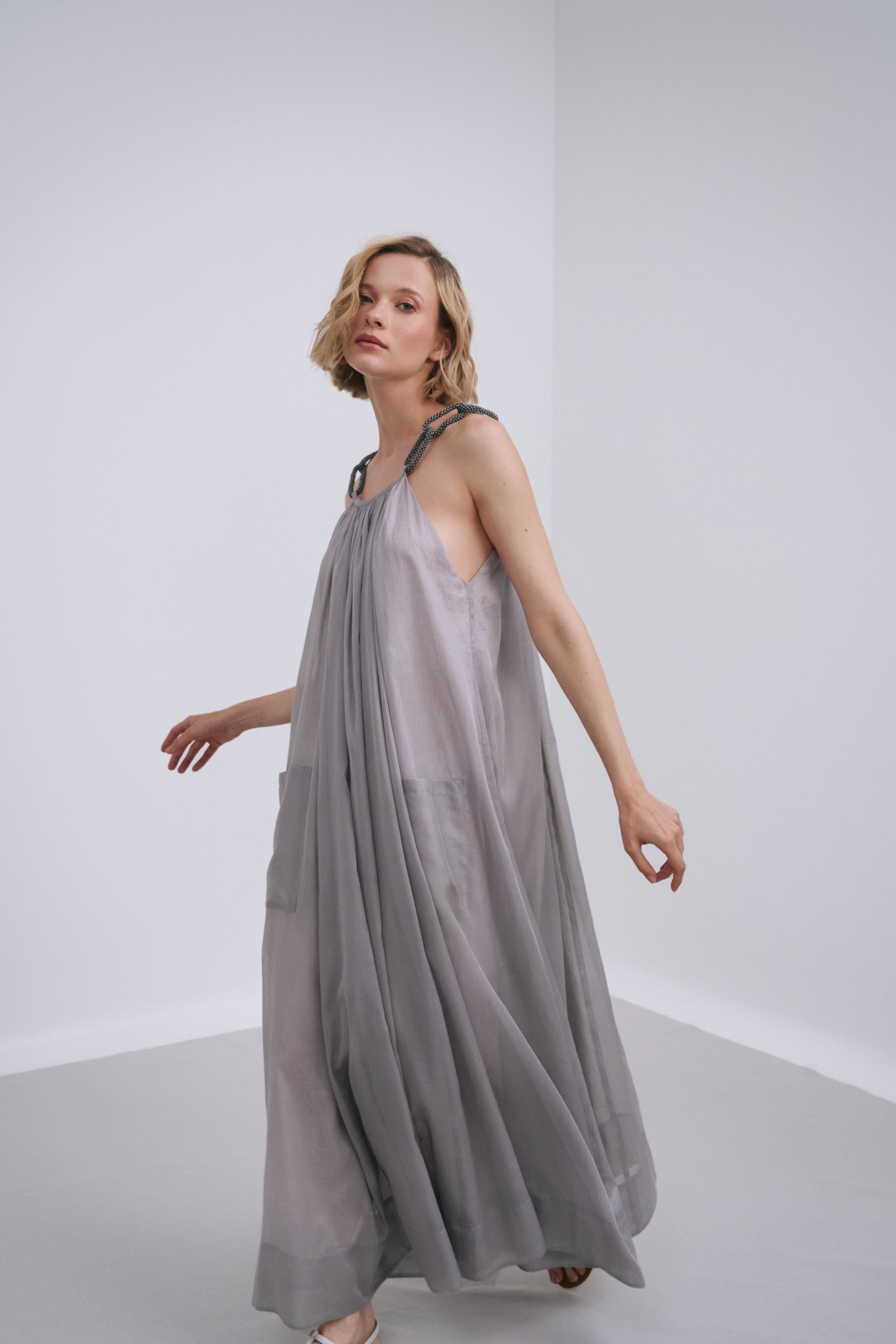 Model wears the Amelia Toro Embroidered Halter Cotton Voile Midi Dress in Red, front view