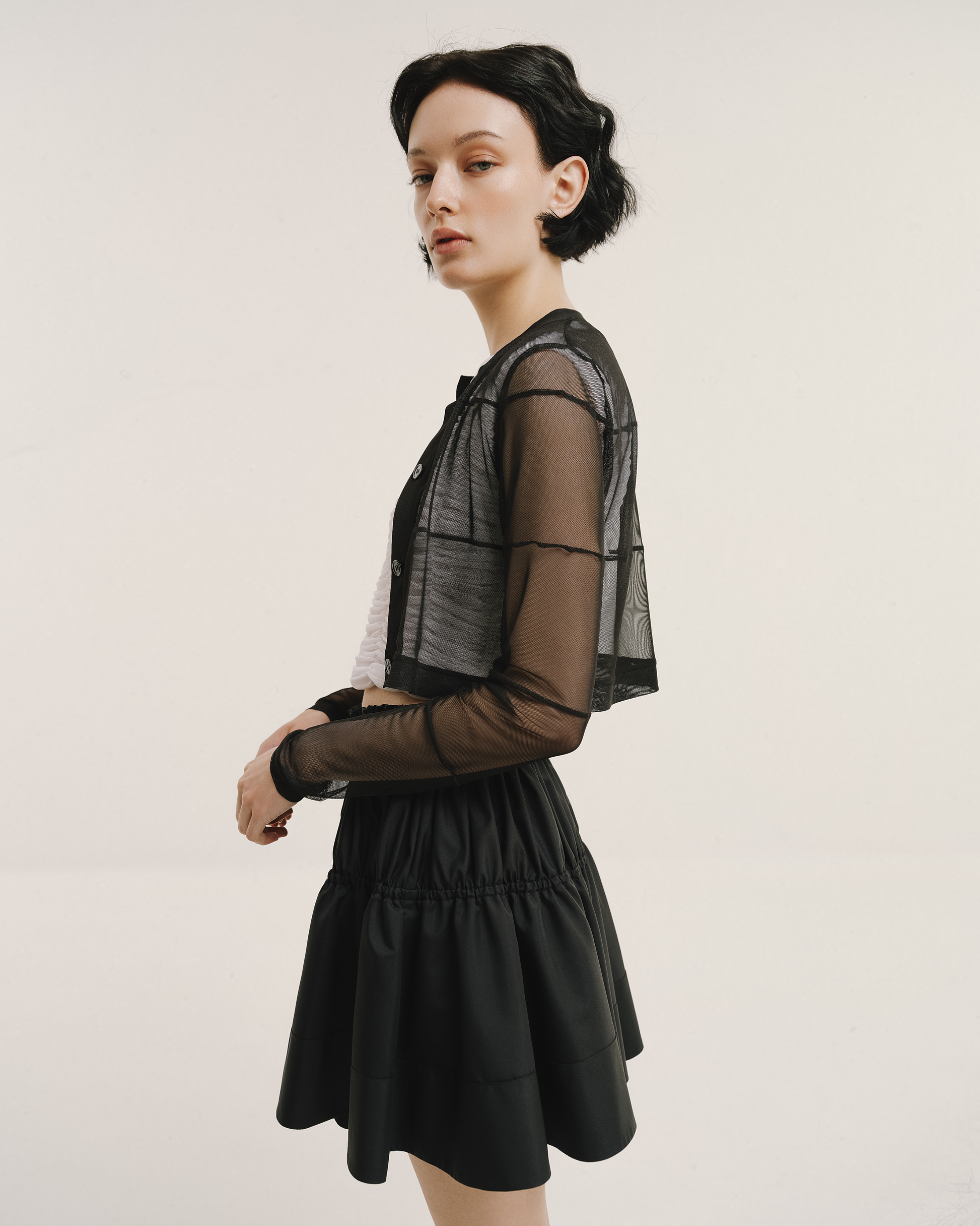 Model wears the Amelia Toro Gathered-Waist Pleated Mini Skirt in red, front view