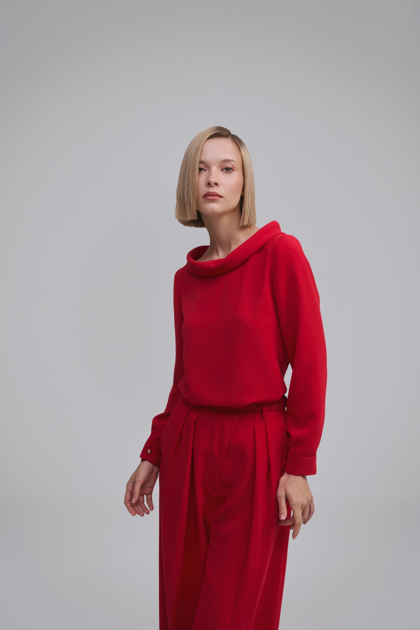 Model wears the Amelia Toro High-Neck Long-Sleeve Cady Blouse in White, front view