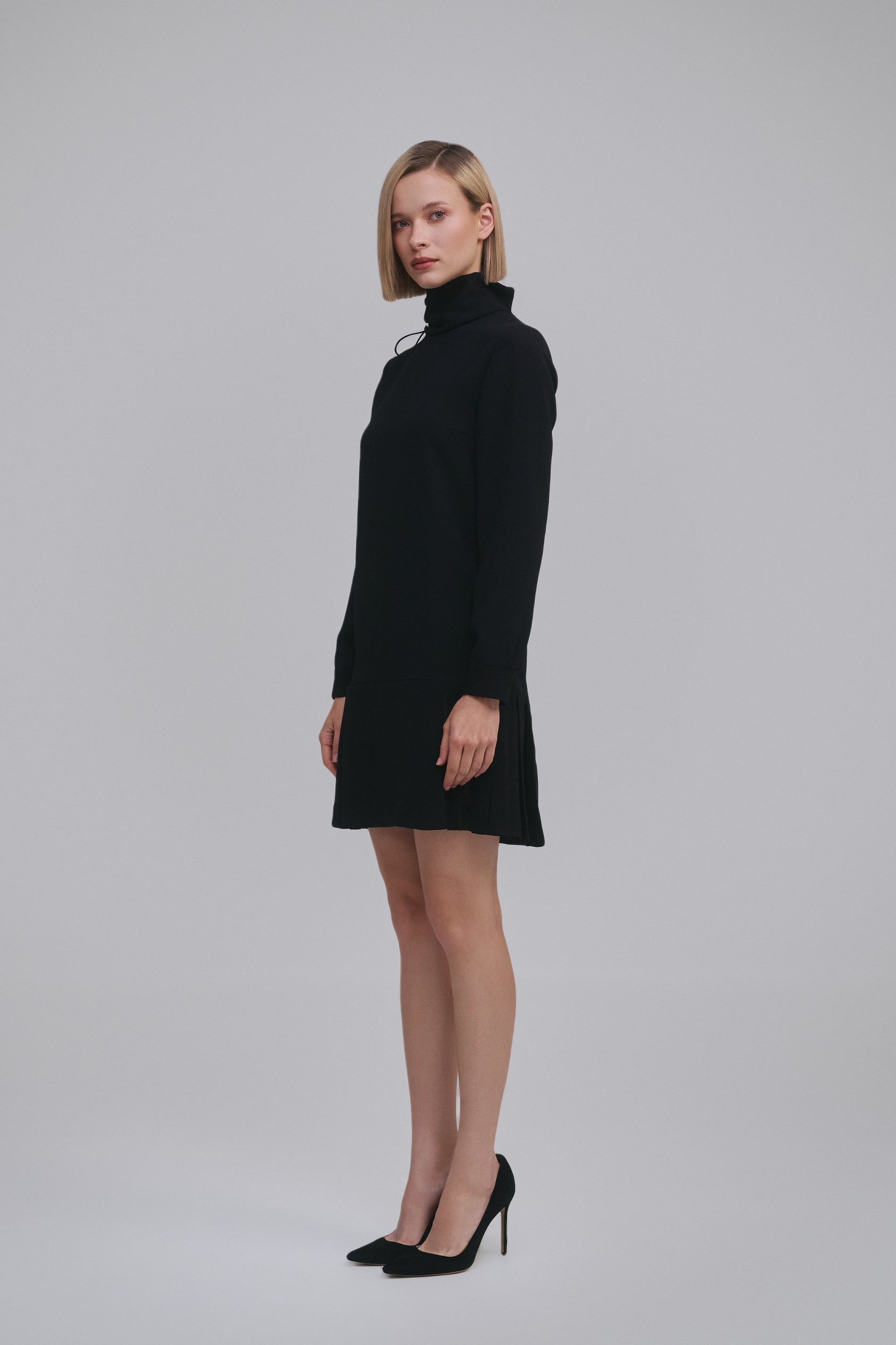 Model wears the Amelia Toro Long-Sleeve Pleated Chiffon Mini Dress in Black, front view