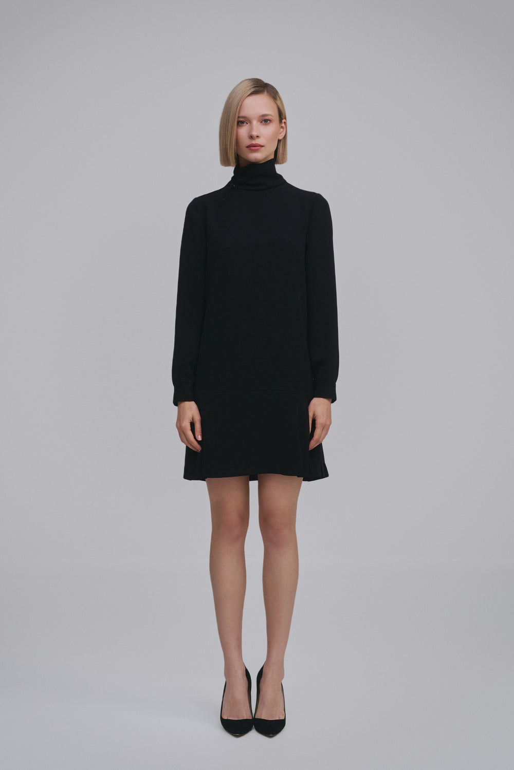 Model wears the Amelia Toro Long-Sleeve Pleated Chiffon Mini Dress in Black, front view