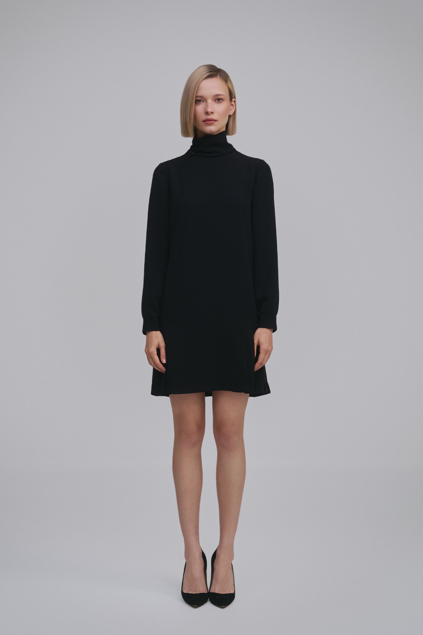 Model wears the Amelia Toro Long-Sleeve Pleated Chiffon Mini Dress in Black, front view