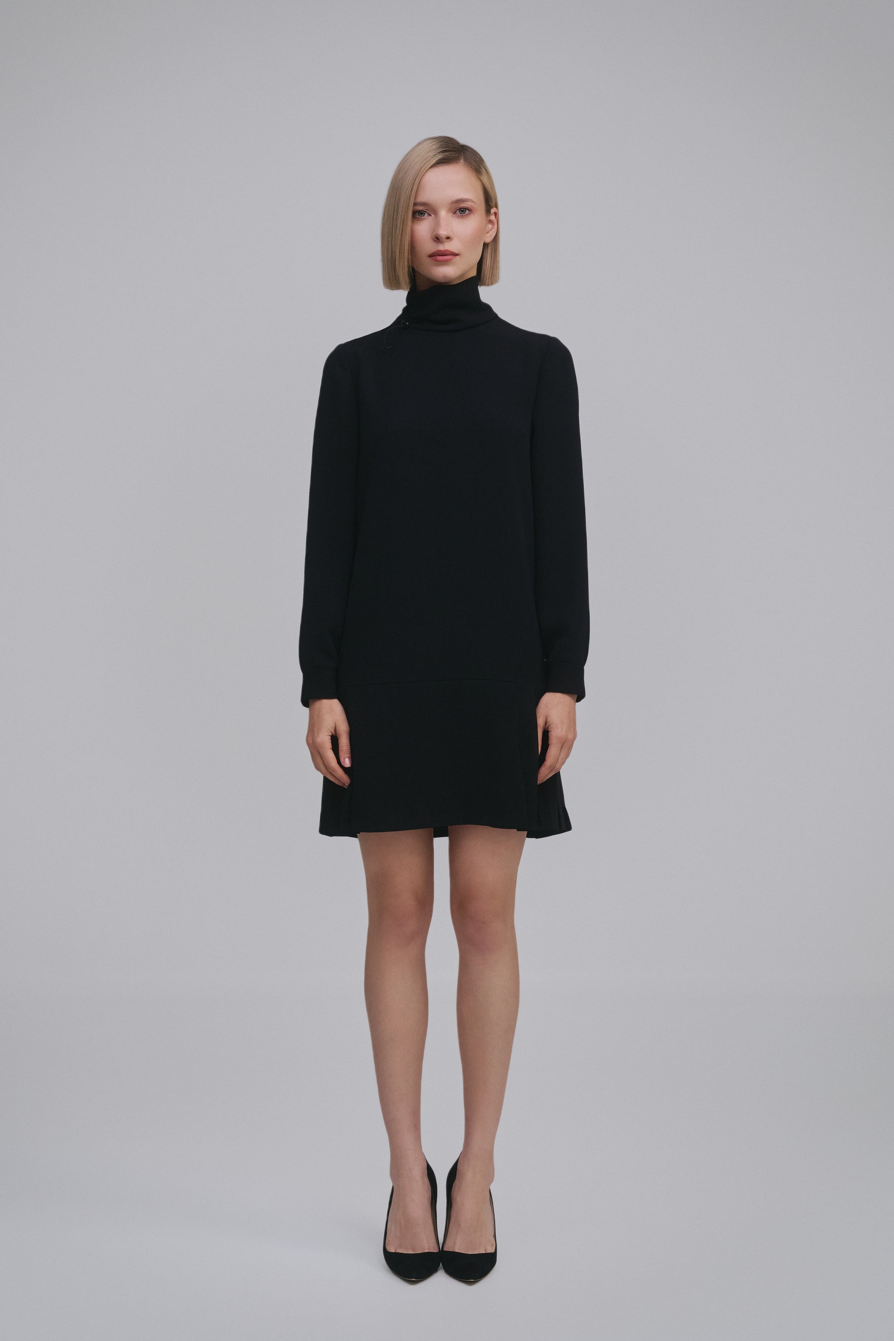 Model wears the Amelia Toro Long-Sleeve Pleated Chiffon Mini Dress in Black, front view