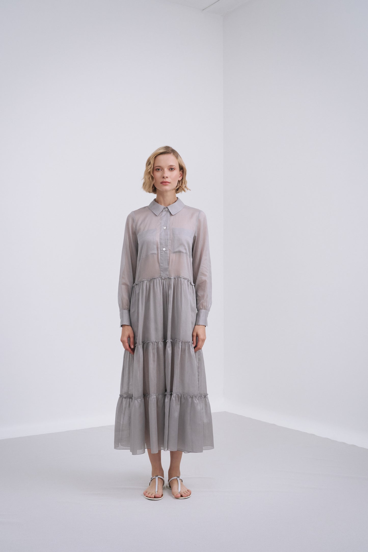 Model wears the Amelia Toro Long-Sleeve Ruffle-Skirt Cotton Voile Midi Dress in Gray, front view