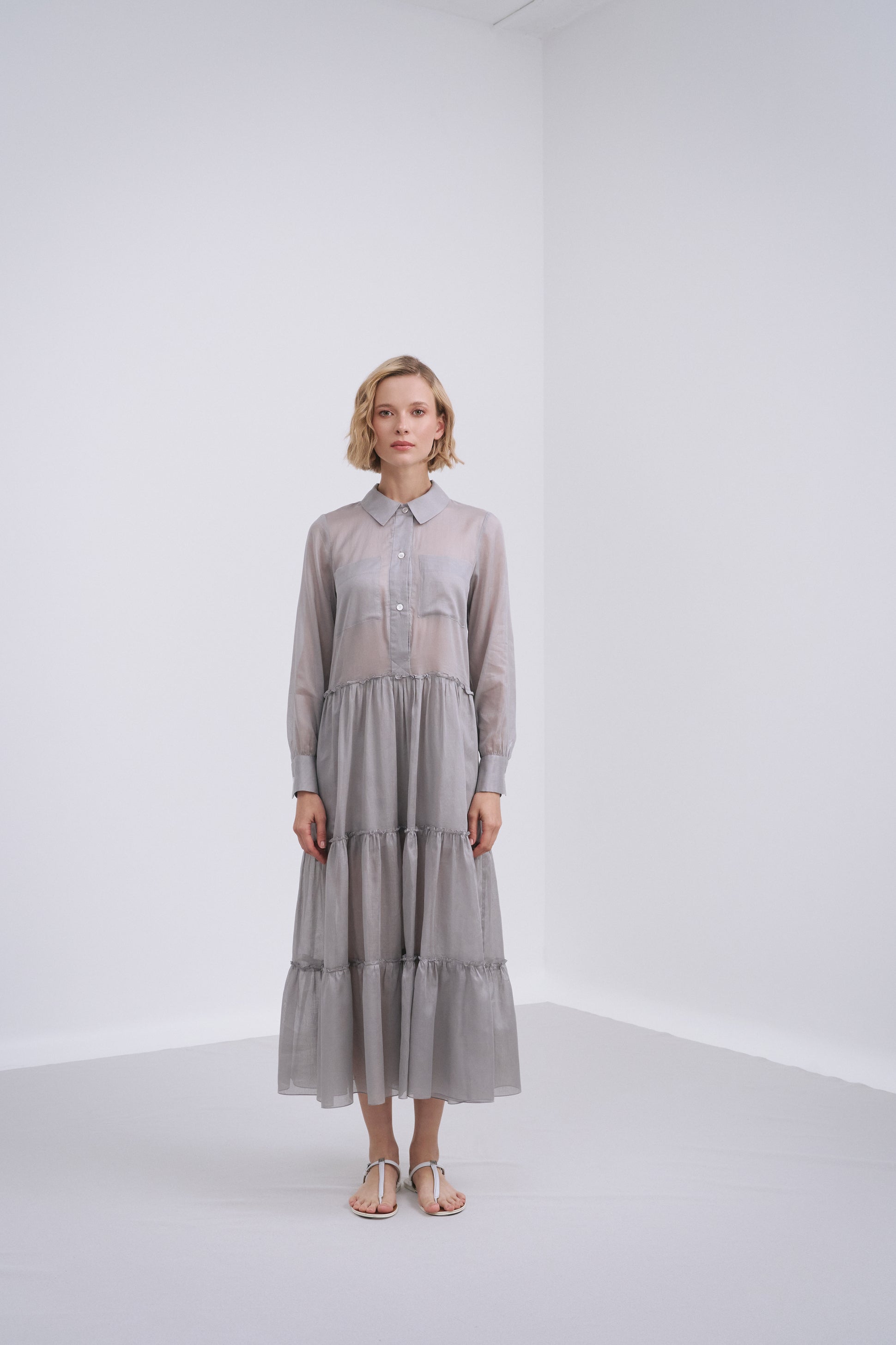 Model wears the Amelia Toro Long-Sleeve Ruffle-Skirt Cotton Voile Midi Dress in Gray, front view