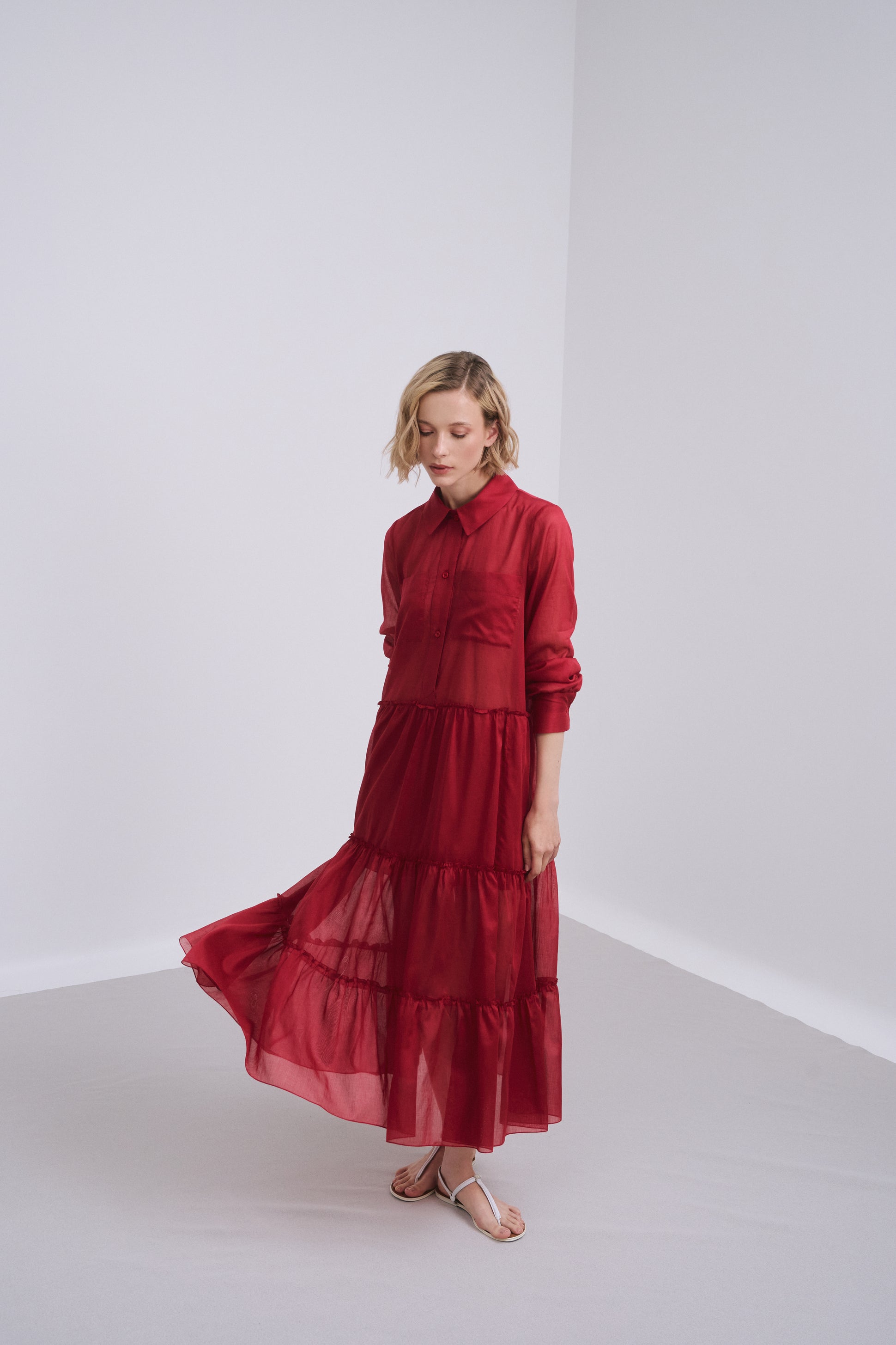 Model wears the Amelia Toro Long-Sleeve Ruffle-Skirt Cotton Voile Midi Dress in Red, front view