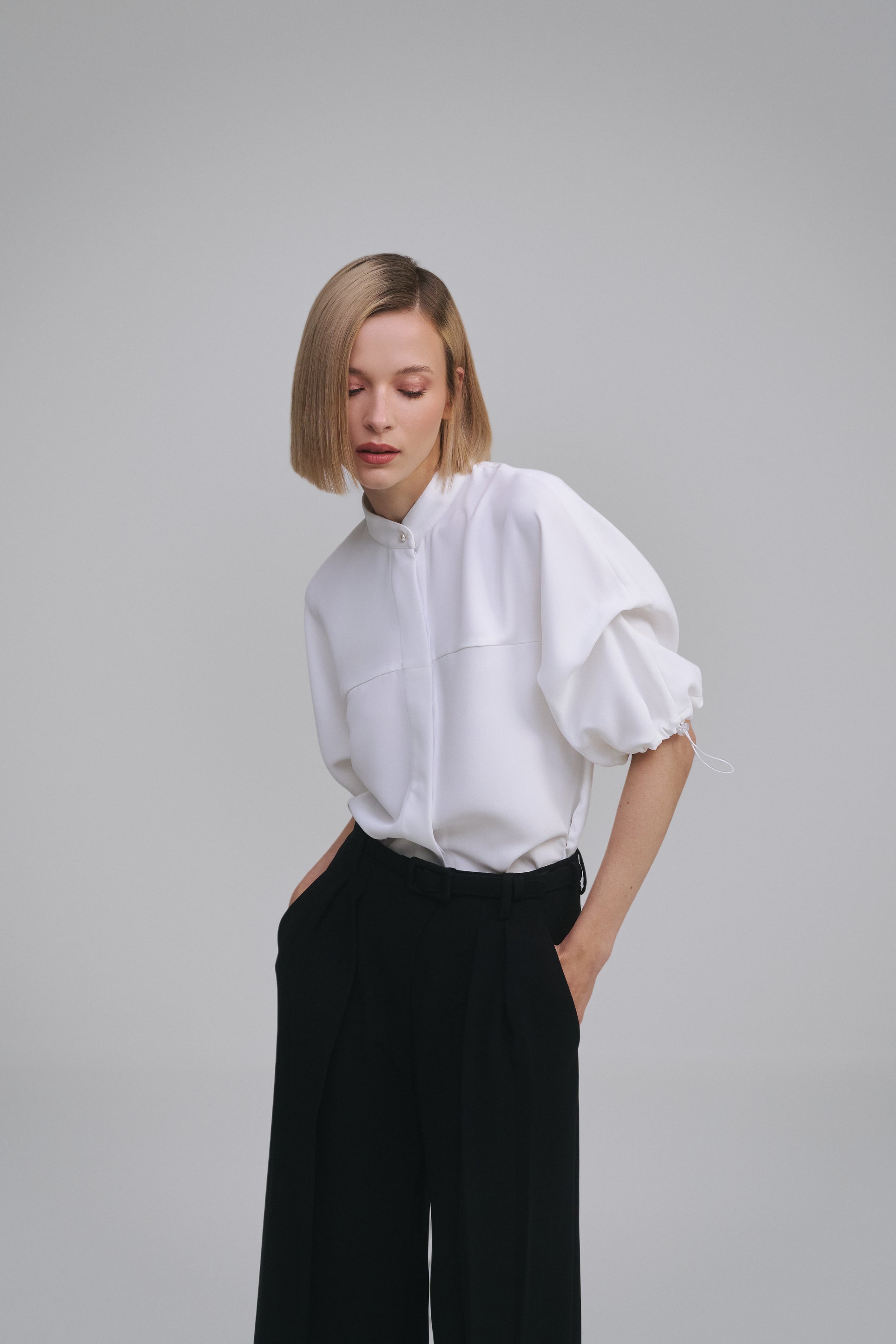Model wears the Amelia Toro Nehru-Collar Kimono-Sleeve Blouse in Red, front view