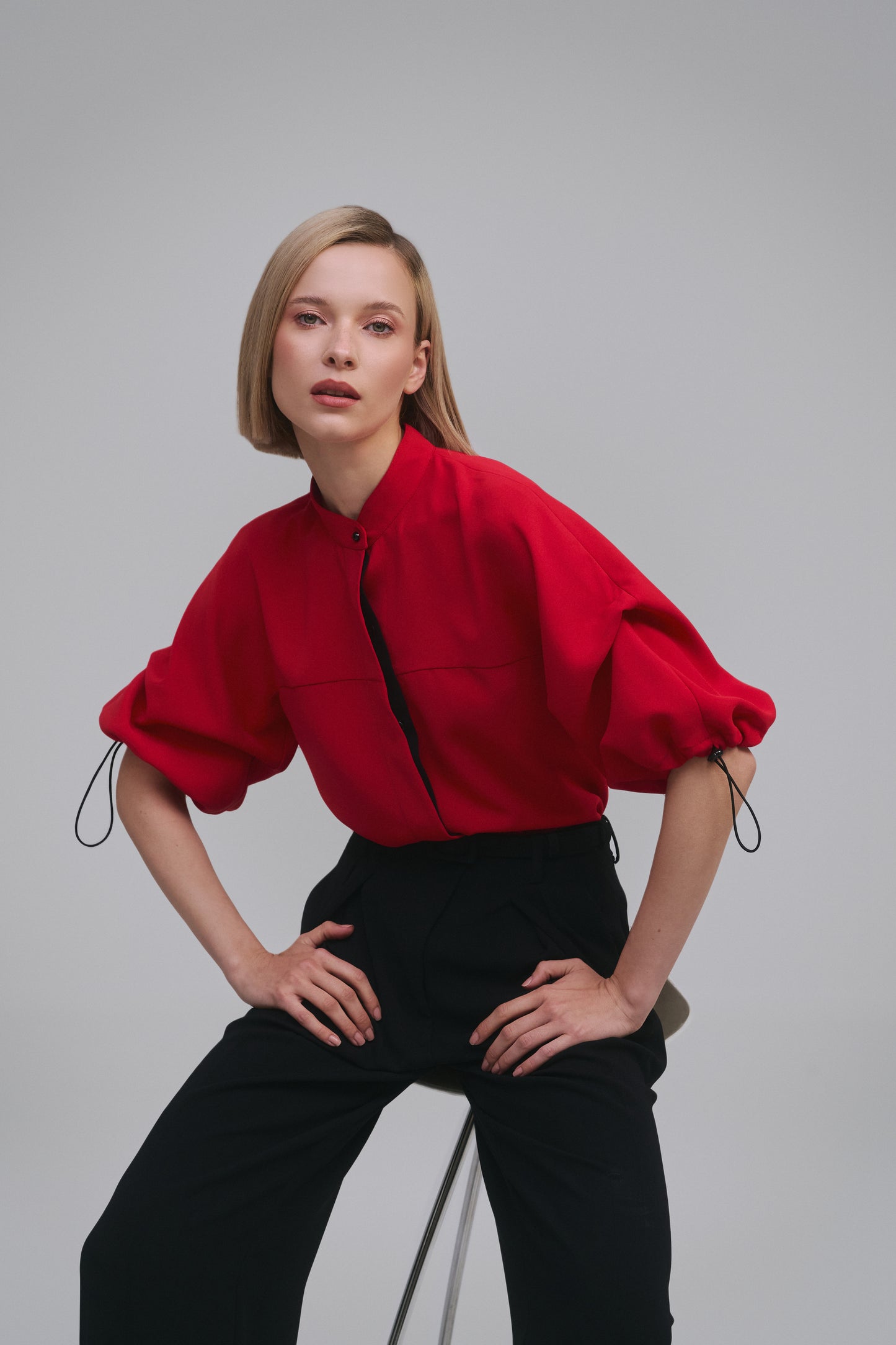 Model wears the Amelia Toro Nehru-Collar Kimono-Sleeve Blouse in Red, front view