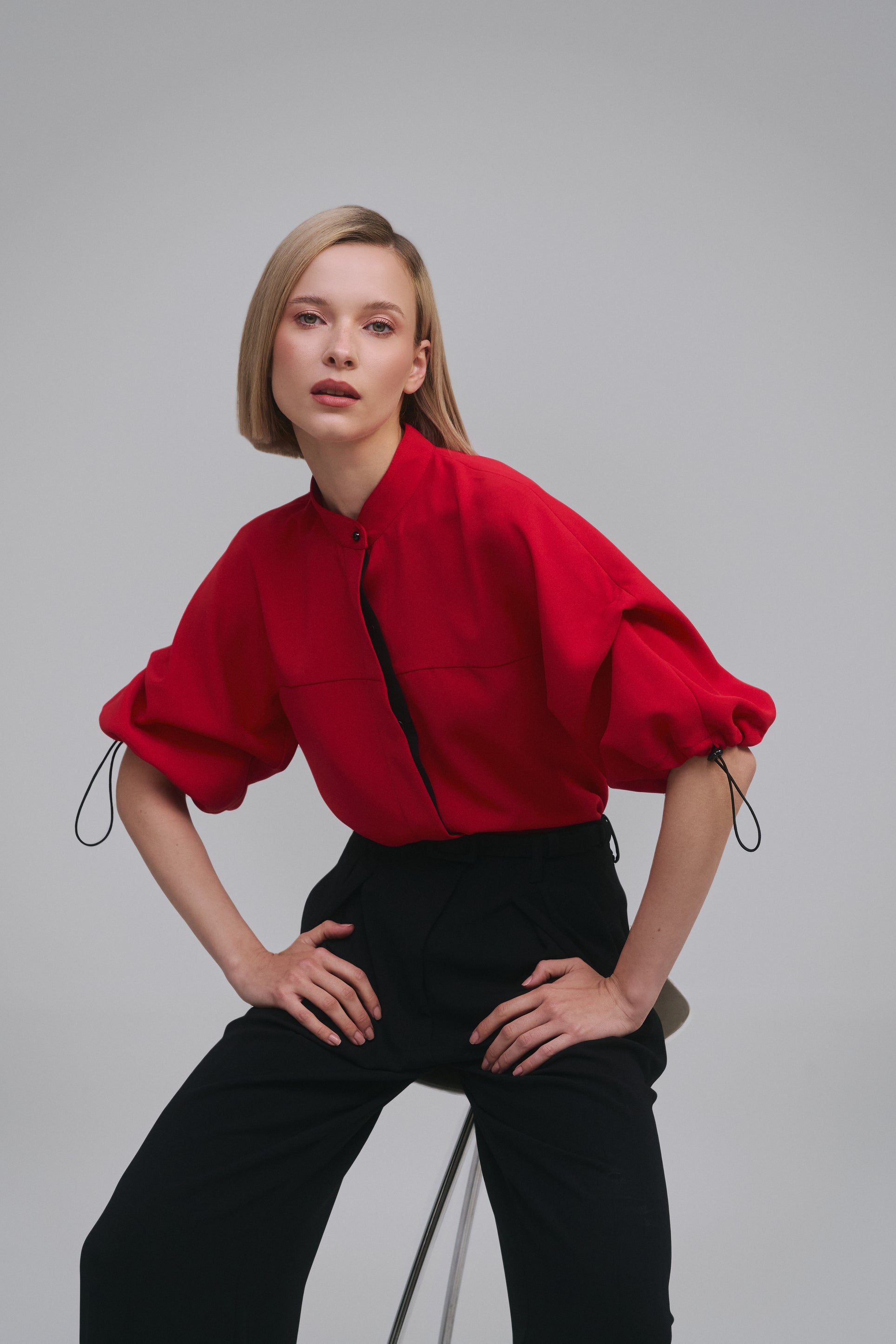 Model wears the Amelia Toro Nehru-Collar Kimono-Sleeve Blouse in Red, front view