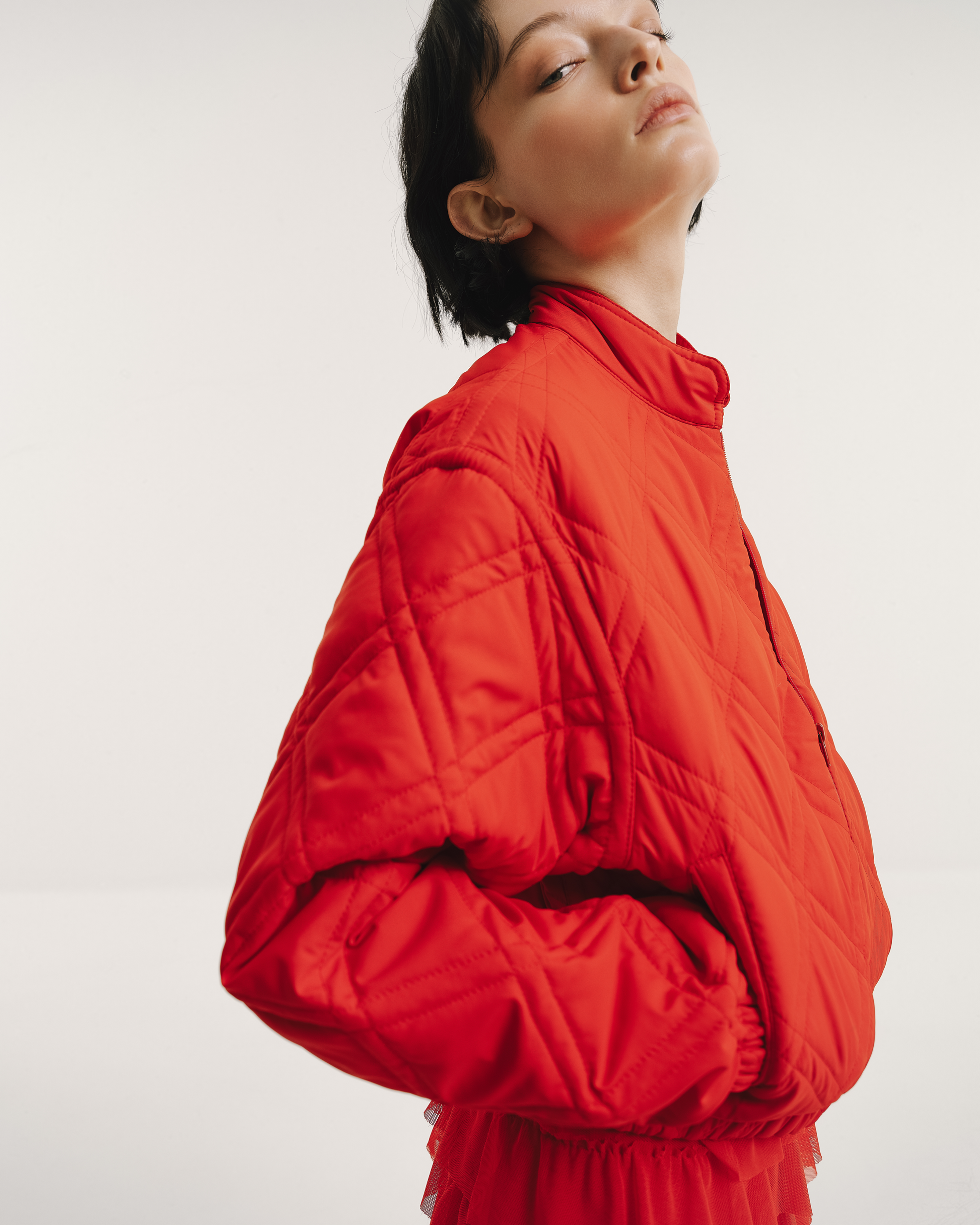 Model wears the Amelia Toro Quilted Cropped Bomber Jacket in black, front view