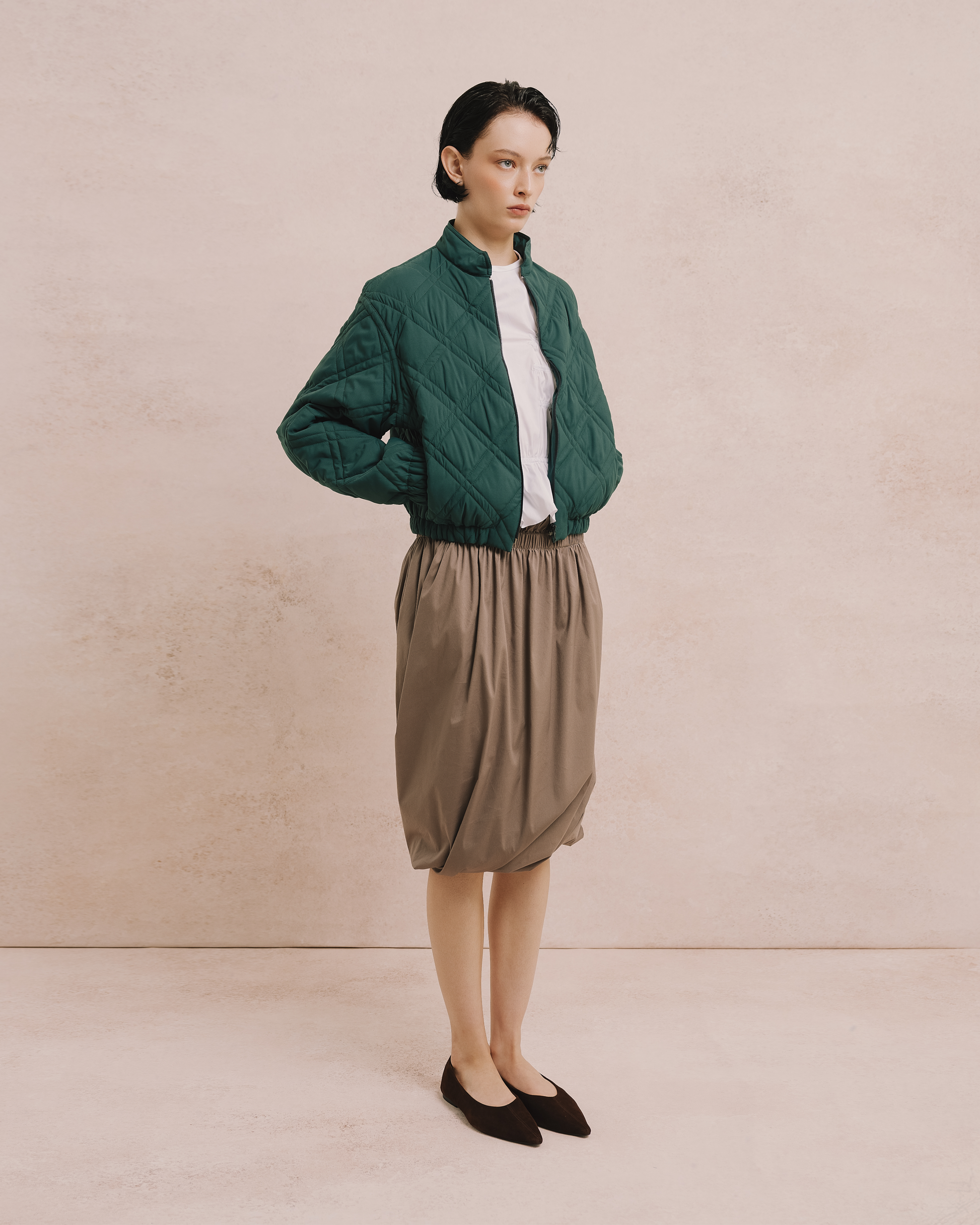 Model wears the Amelia Toro Quilted Cropped Bomber Jacket in black, front view