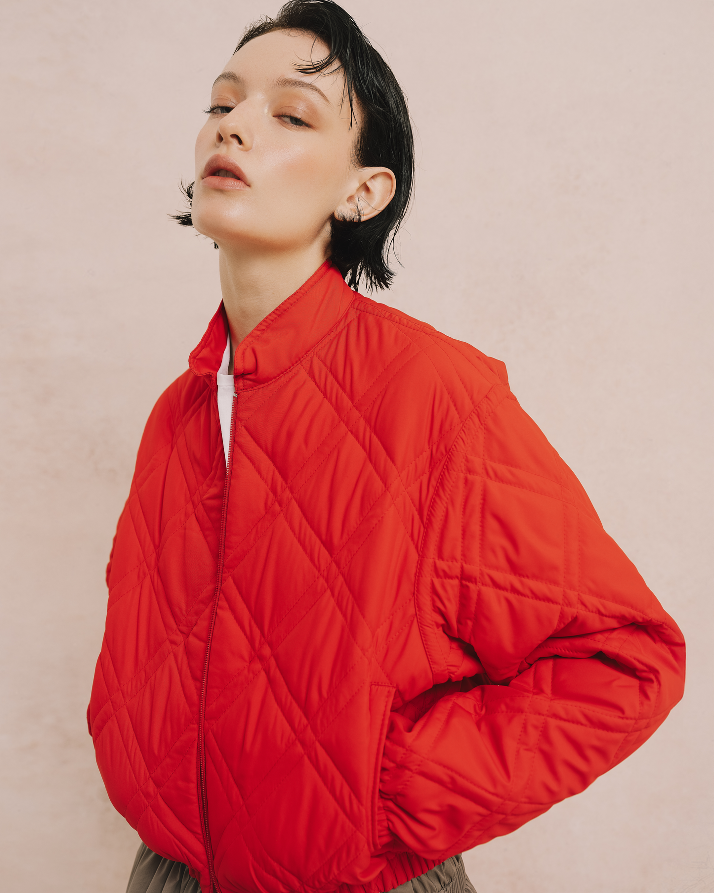 Model wears the Amelia Toro Quilted Cropped Bomber Jacket in red, front view