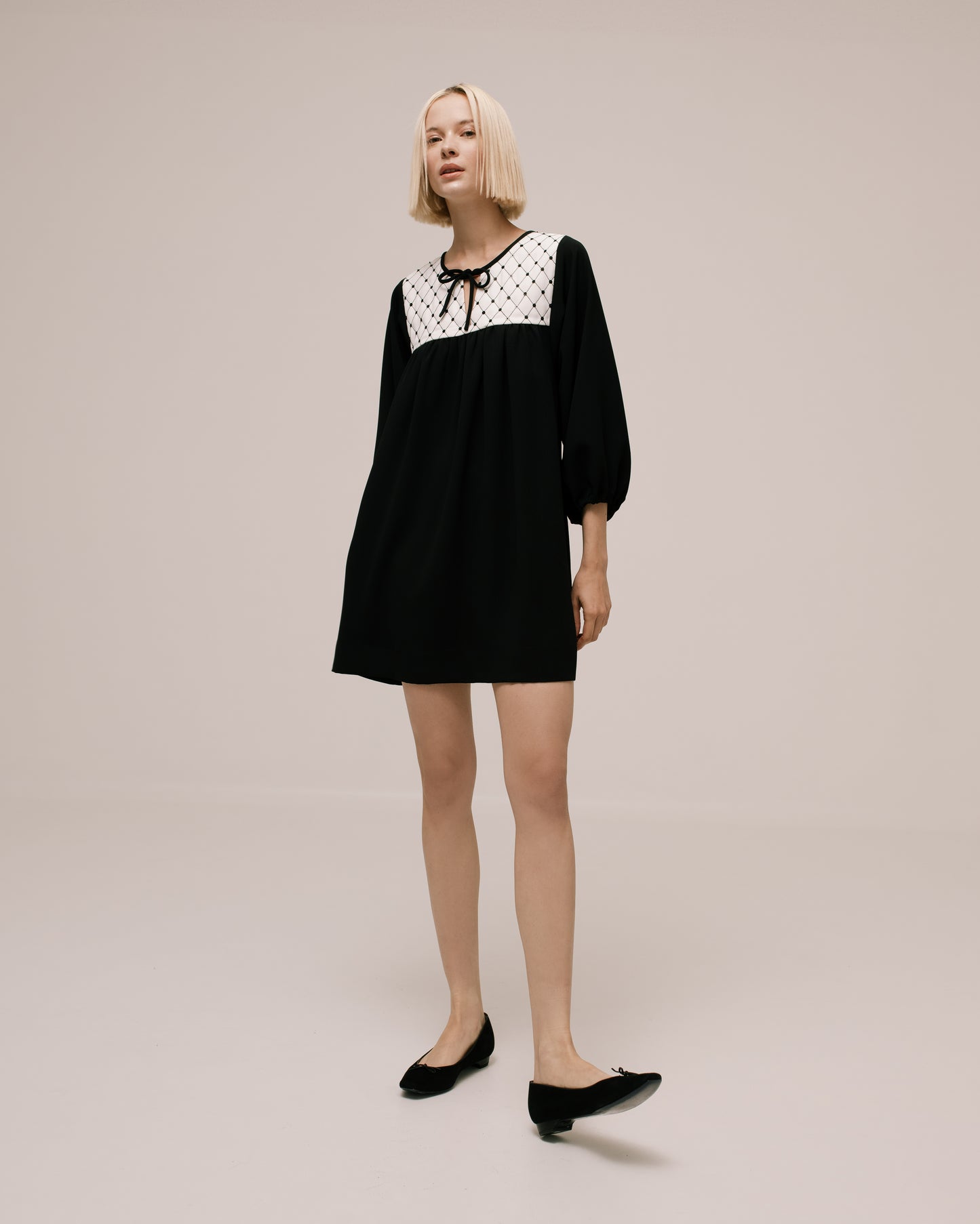Back view of the Amelia Toro Quilted-Front Puff-Sleeve Cady Mini Dress in Black