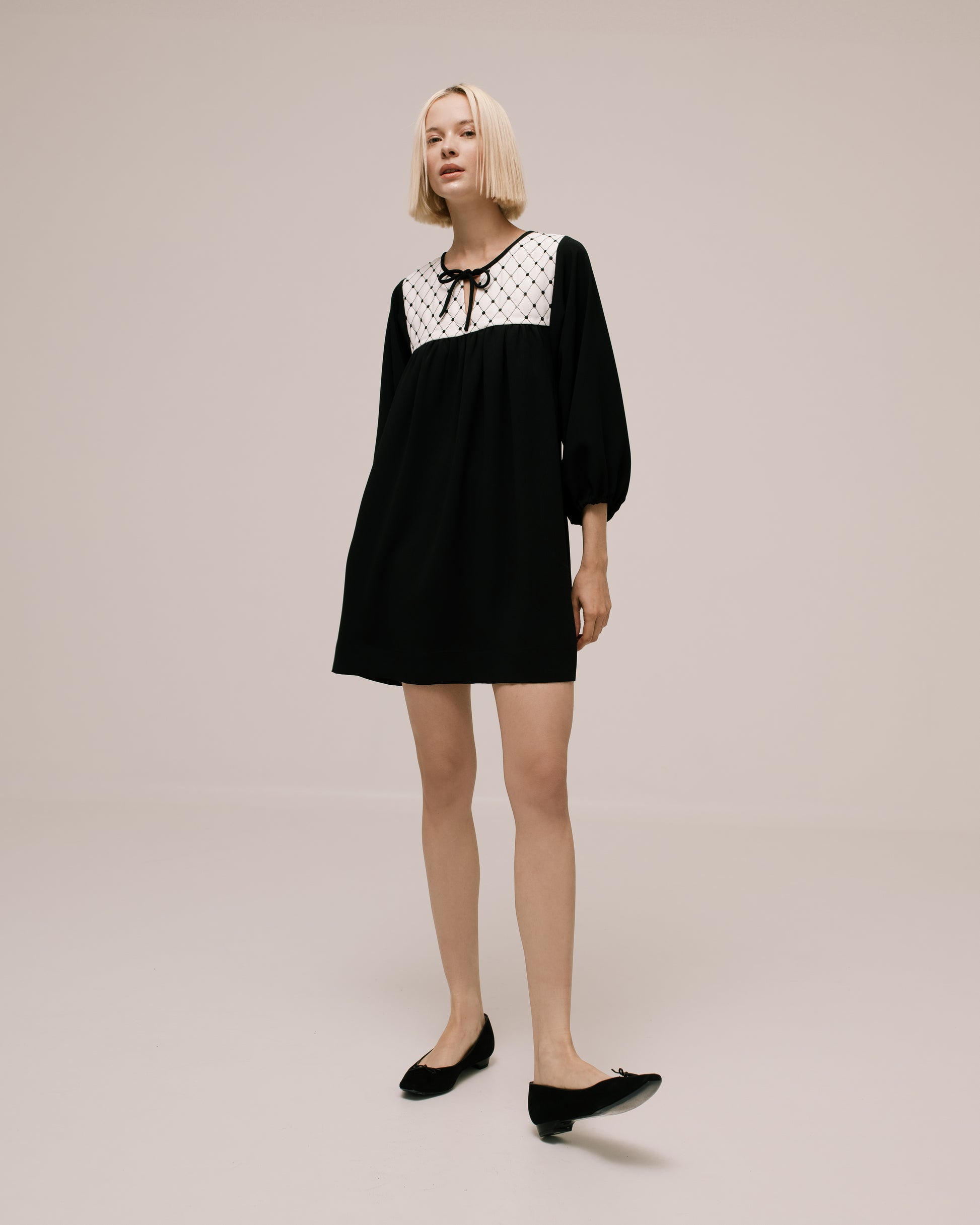 Back view of the Amelia Toro Quilted-Front Puff-Sleeve Cady Mini Dress in Black