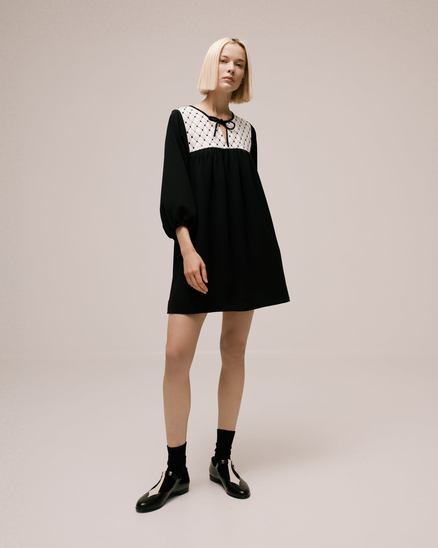 Model wears the Amelia Toro Quilted-Front Puff-Sleeve Cady Mini Dress in Black, front view