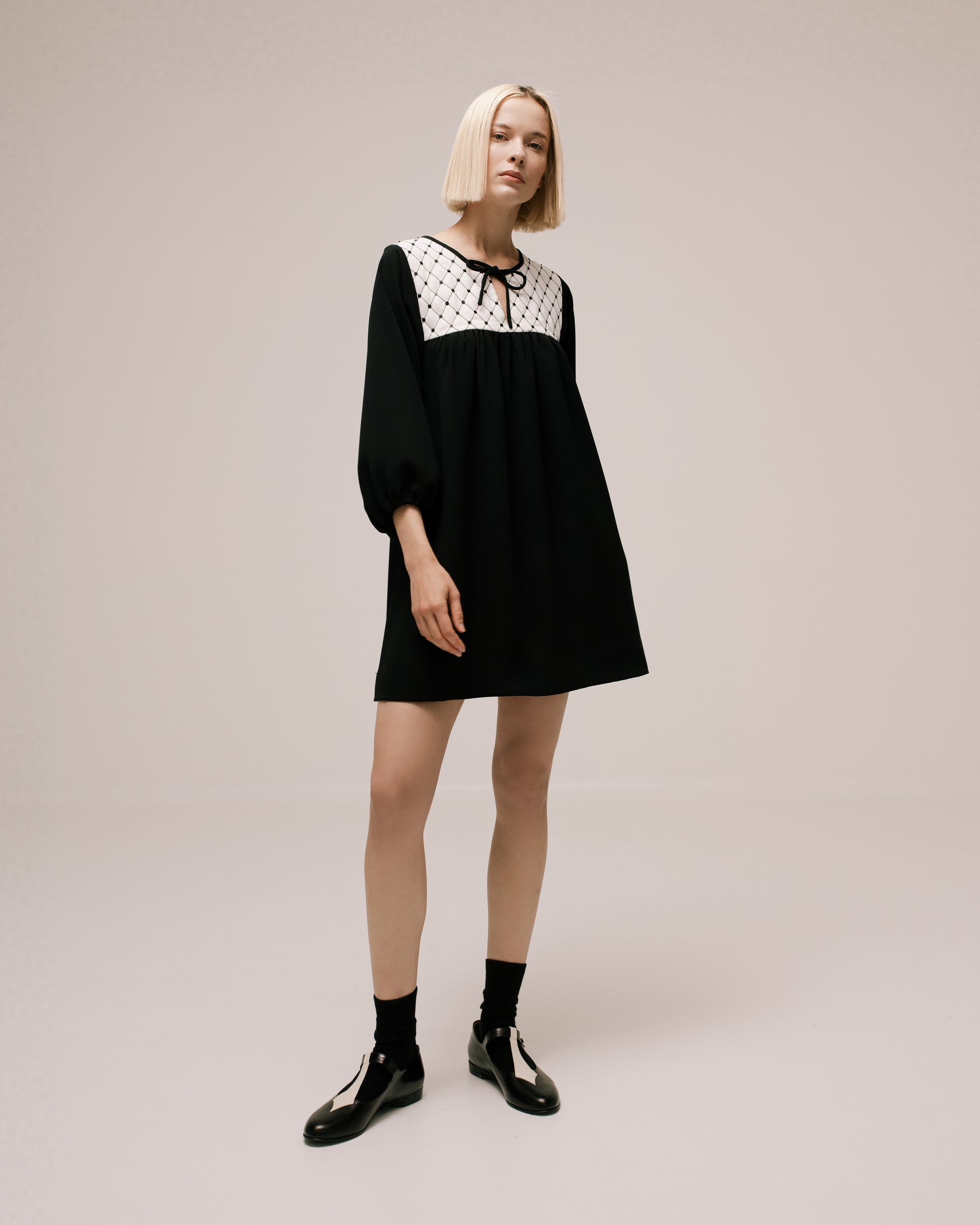 Model wears the Amelia Toro Quilted-Front Puff-Sleeve Cady Mini Dress in Black, front view
