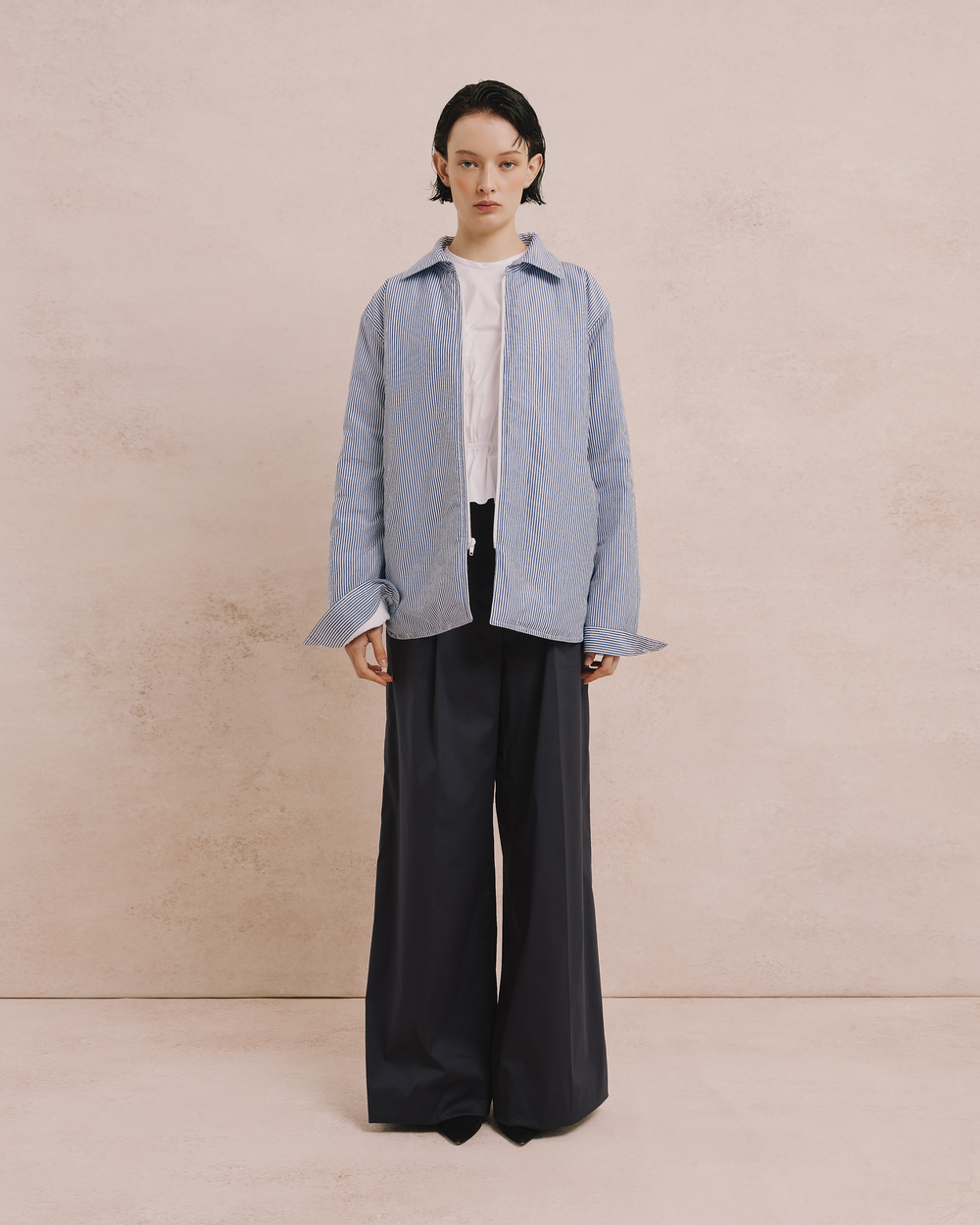 Model wears the Amelia Toro Quilted Striped Cotton Jacket in blue/white, front view