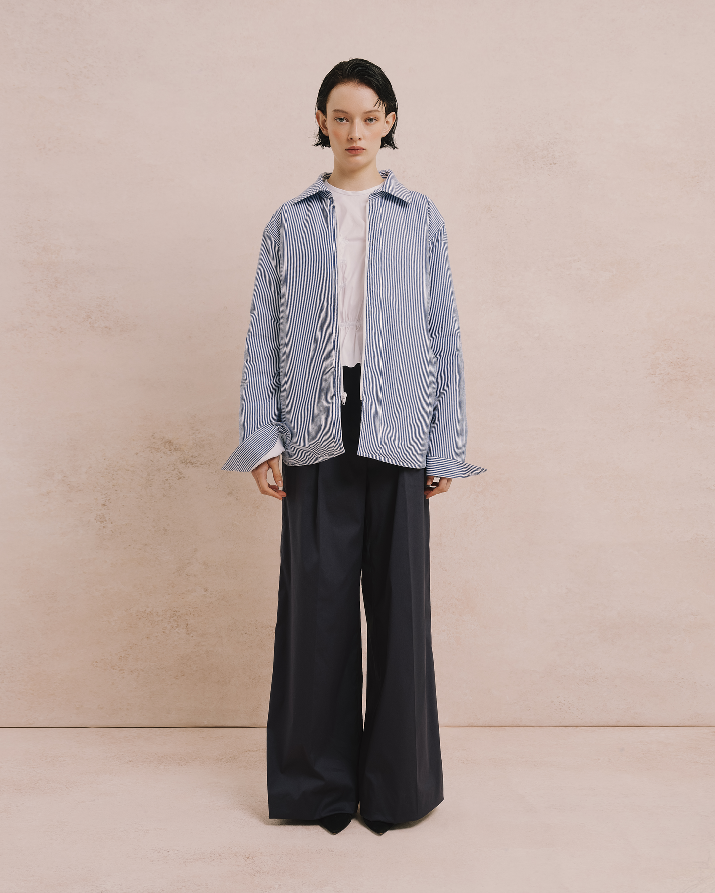 Model wears the Amelia Toro Quilted Striped Cotton Jacket in blue/white, front view