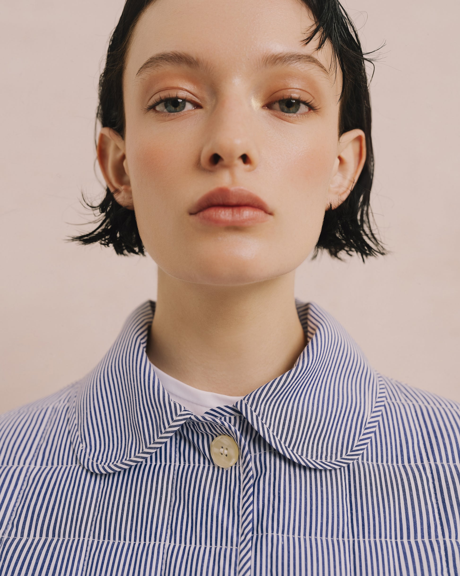 Model wears the Amelia Toro Quilted Striped Spring Jacket in blue/white, front view