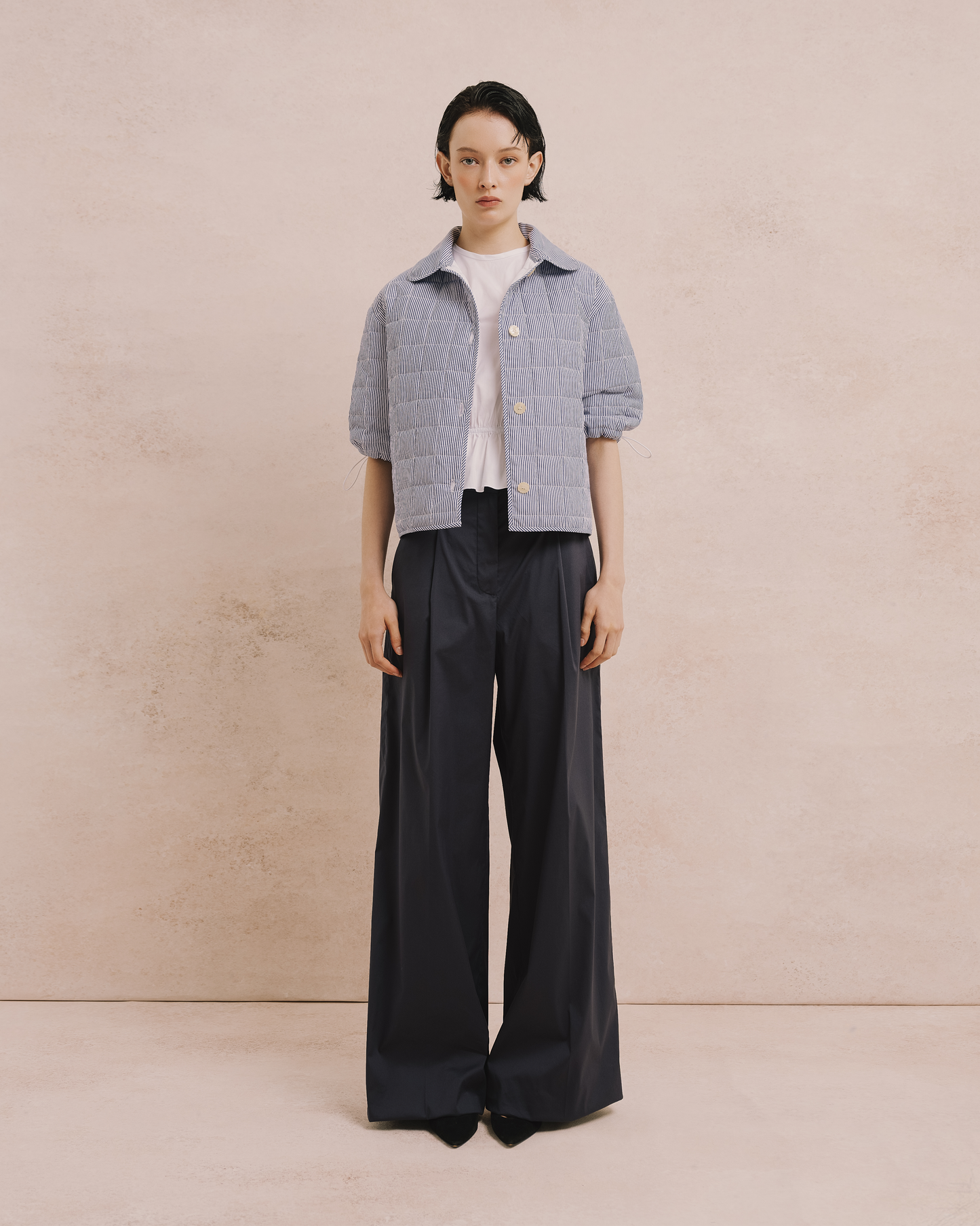 Model wears the Amelia Toro Quilted Striped Spring Jacket in blue/white, front view