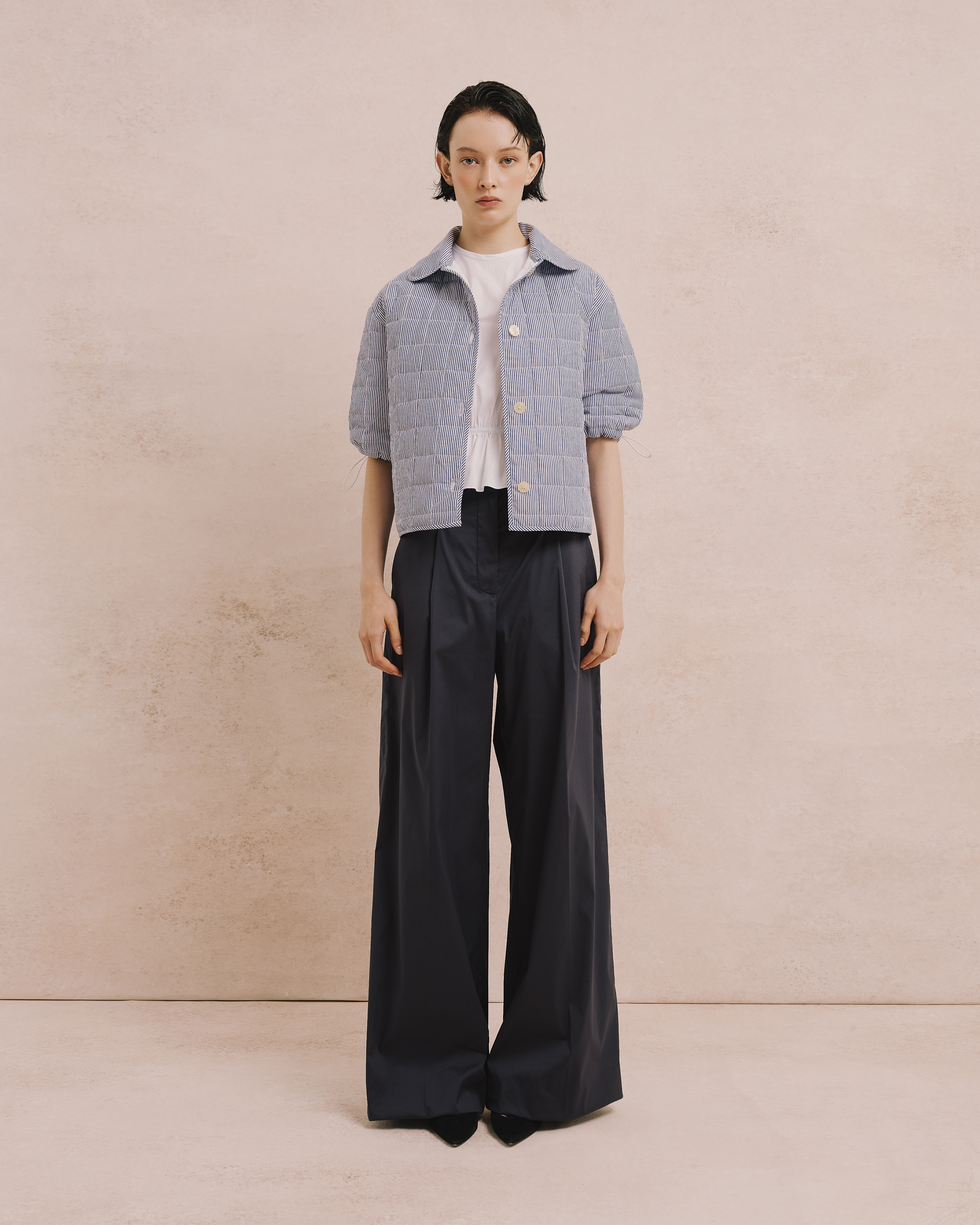 Model wears the Amelia Toro Quilted Striped Spring Jacket in blue/white, front view