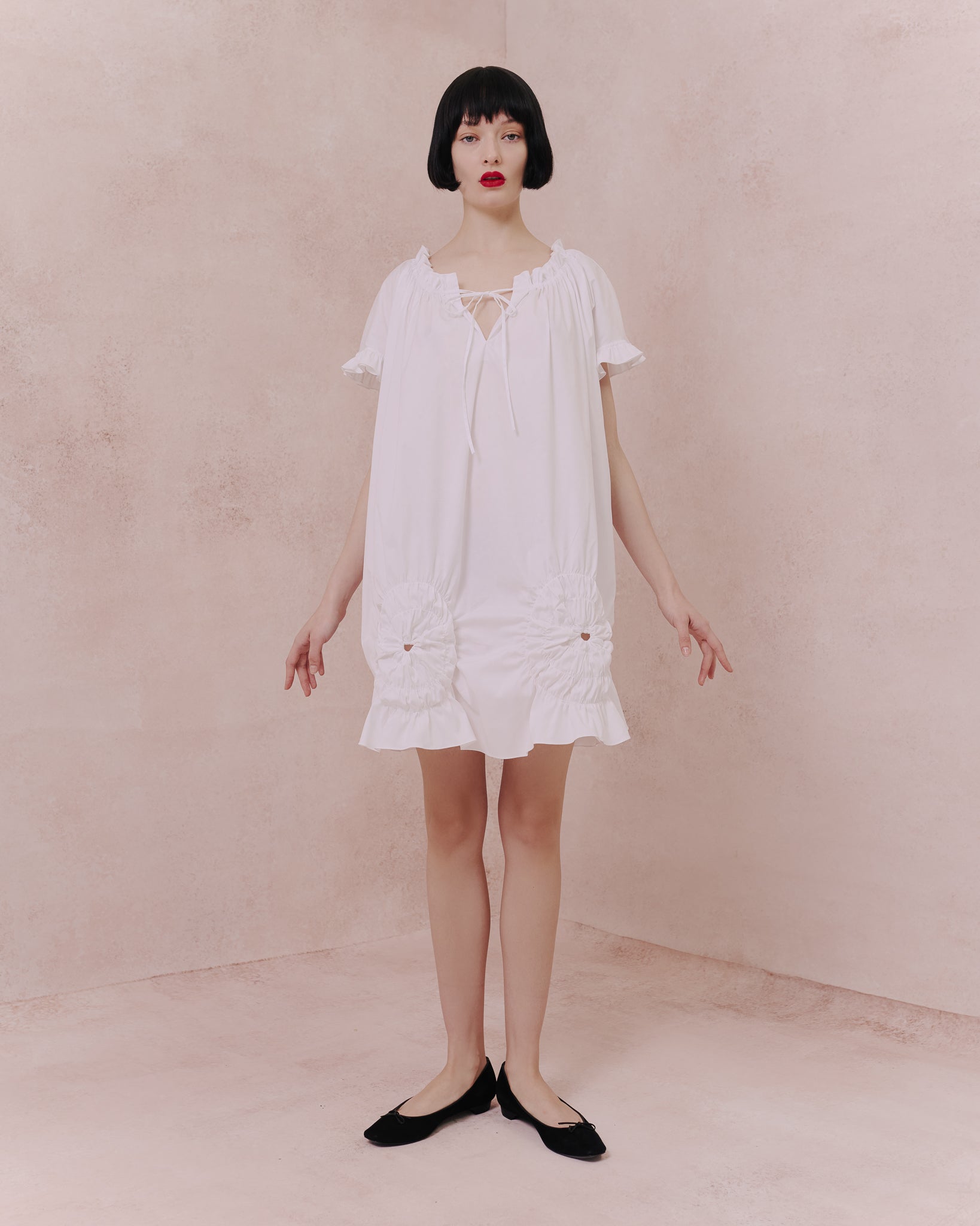 Model wears the Amelia Toro Ruched Cotton Tunic Shirt in white, front view