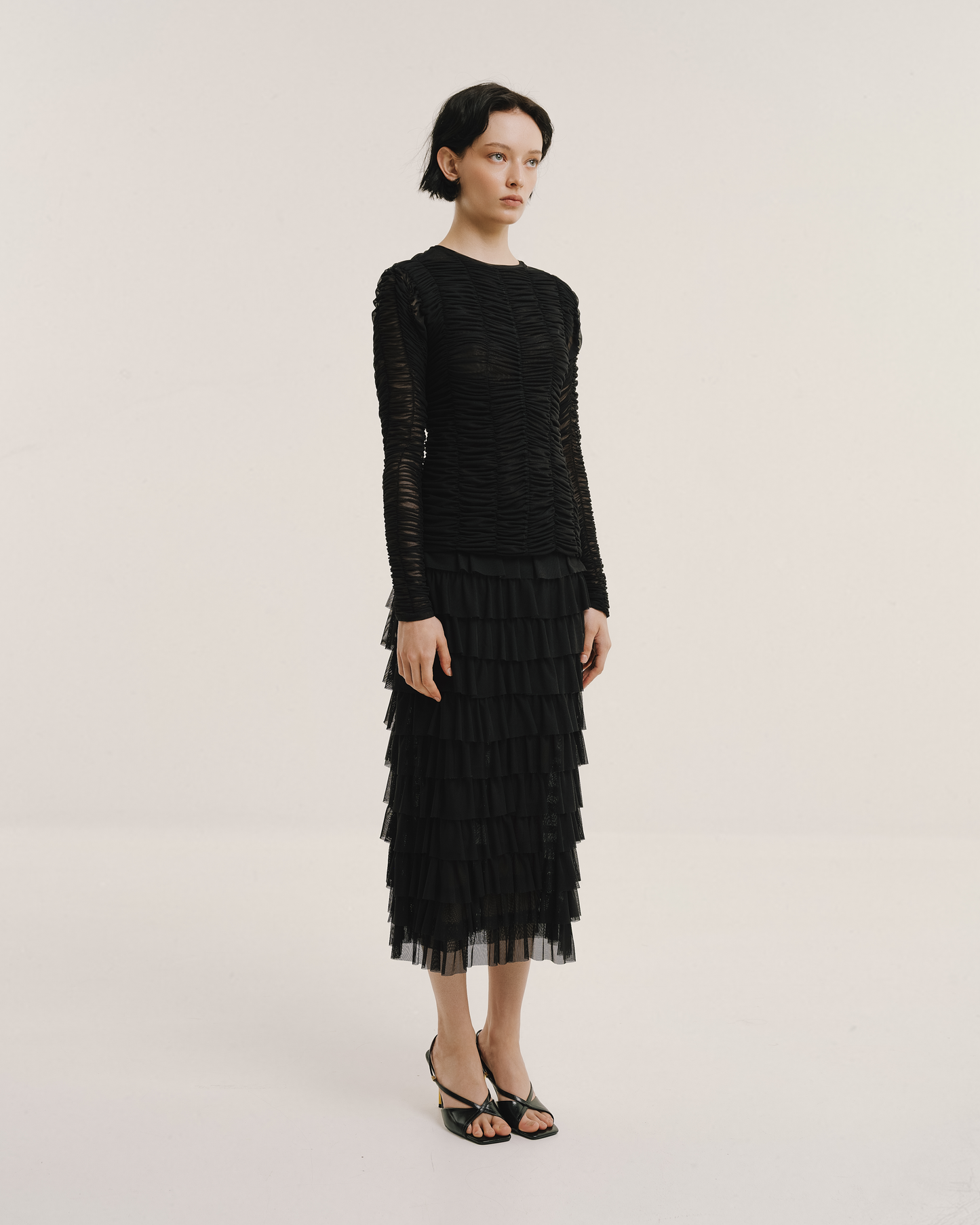 Model wears the Amelia Toro Ruched Tulle Round-Neck Top in black, front view