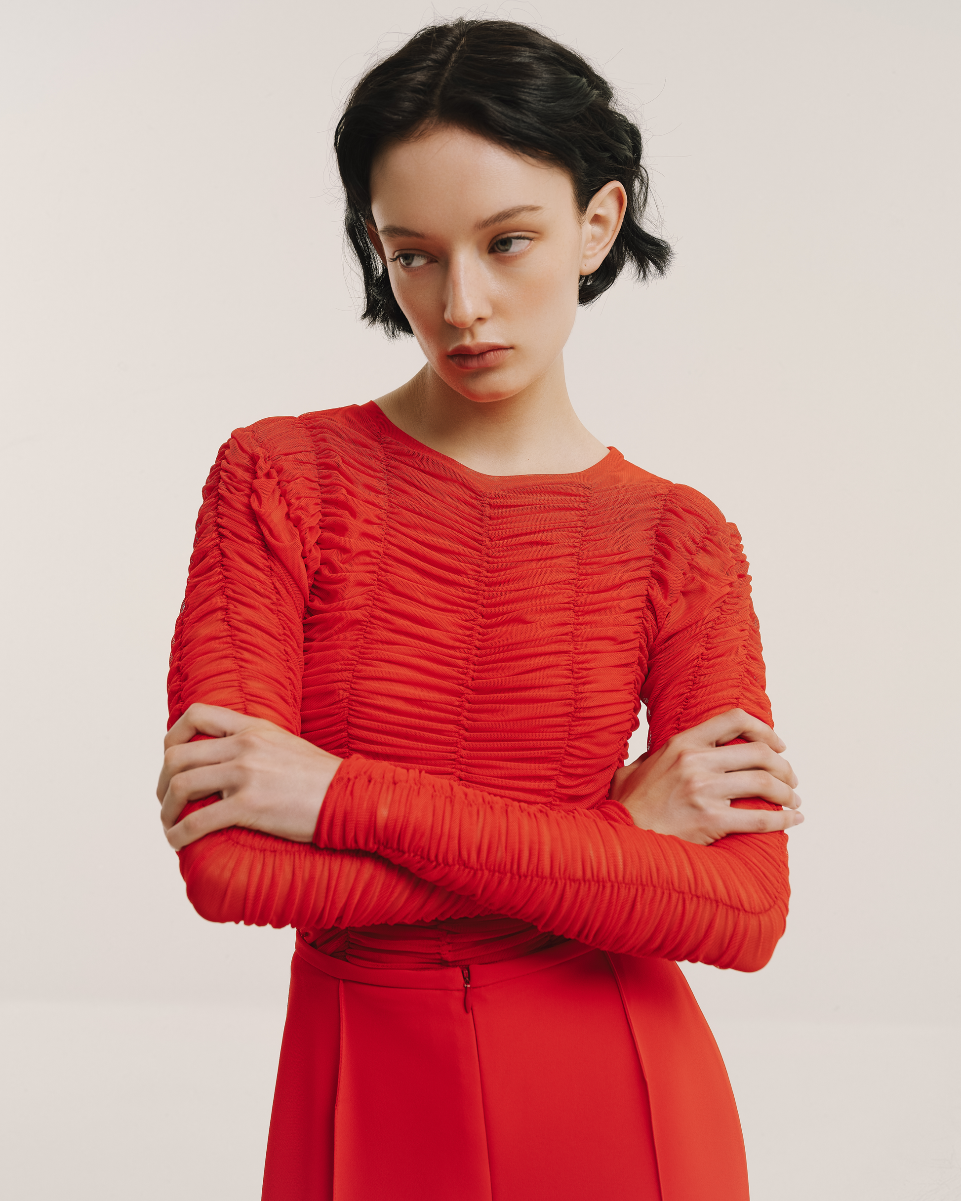 Model wears the Amelia Toro Ruched Tulle Round-Neck Top in red, front view