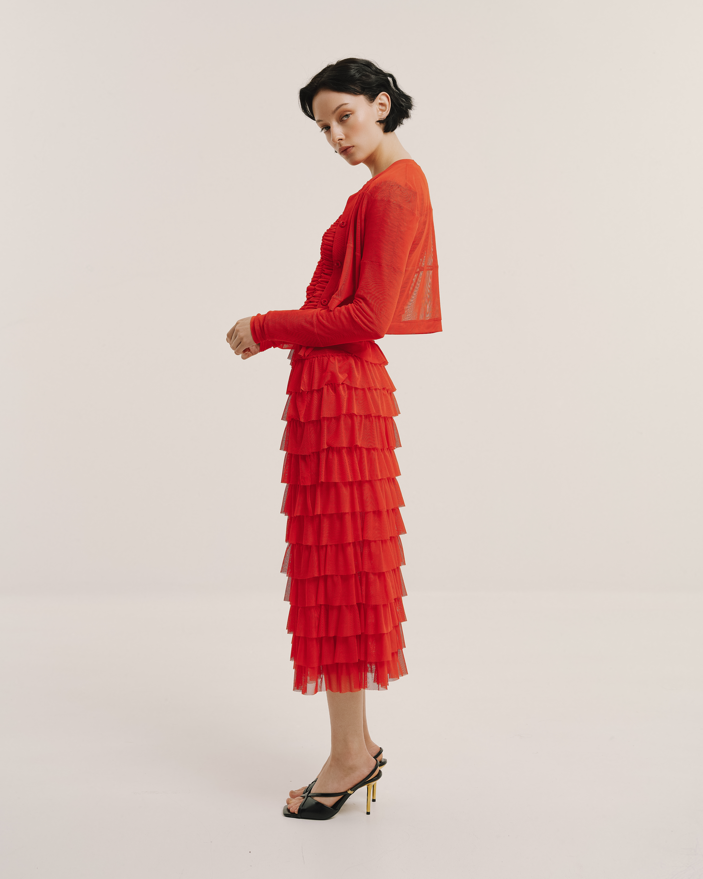 Model wears the Amelia Toro Sheer Tulle Cropped Sweater in black, front view
