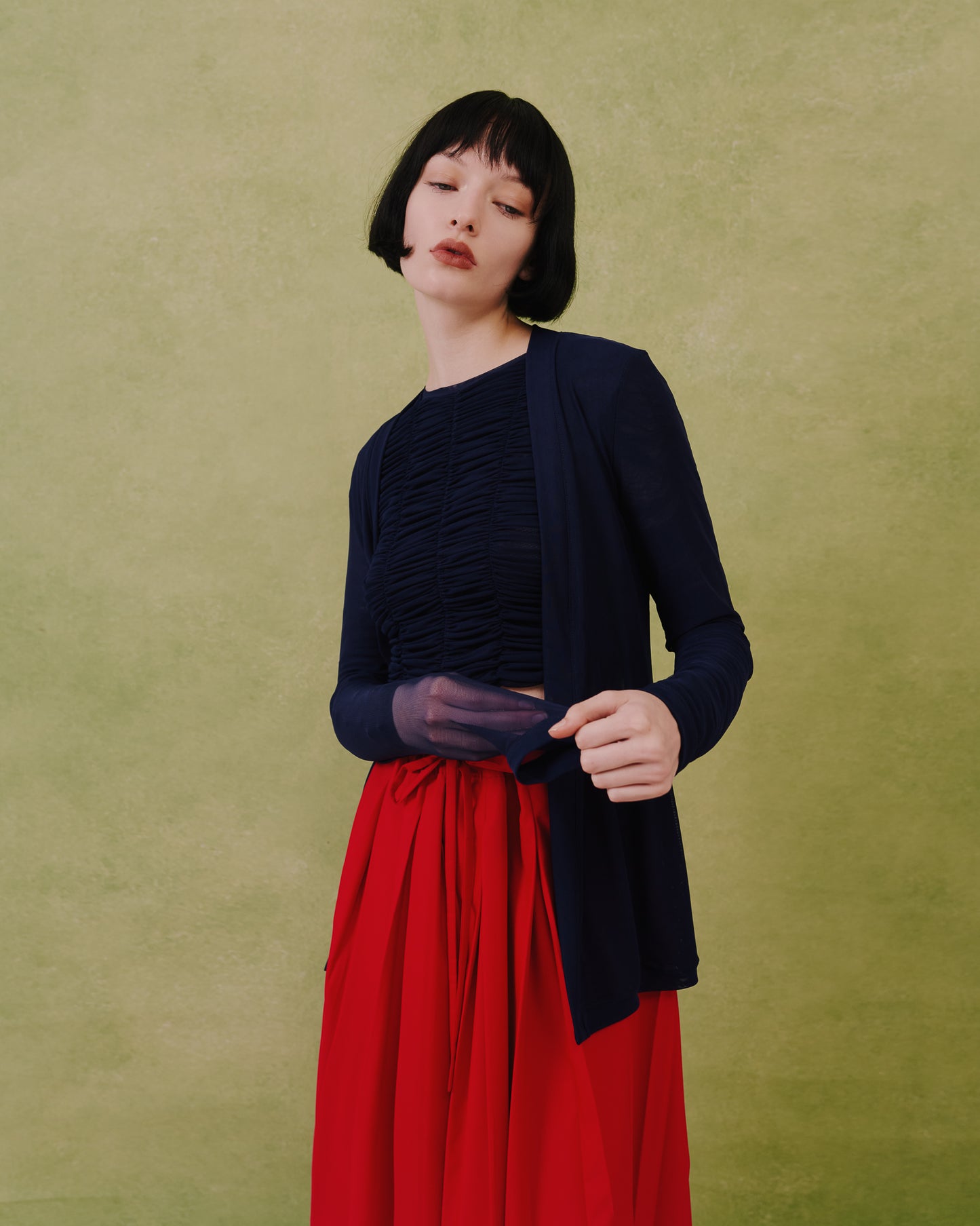 Model wears the Amelia Toro Sheer Tulle Longsleeve Sweater in black, front view