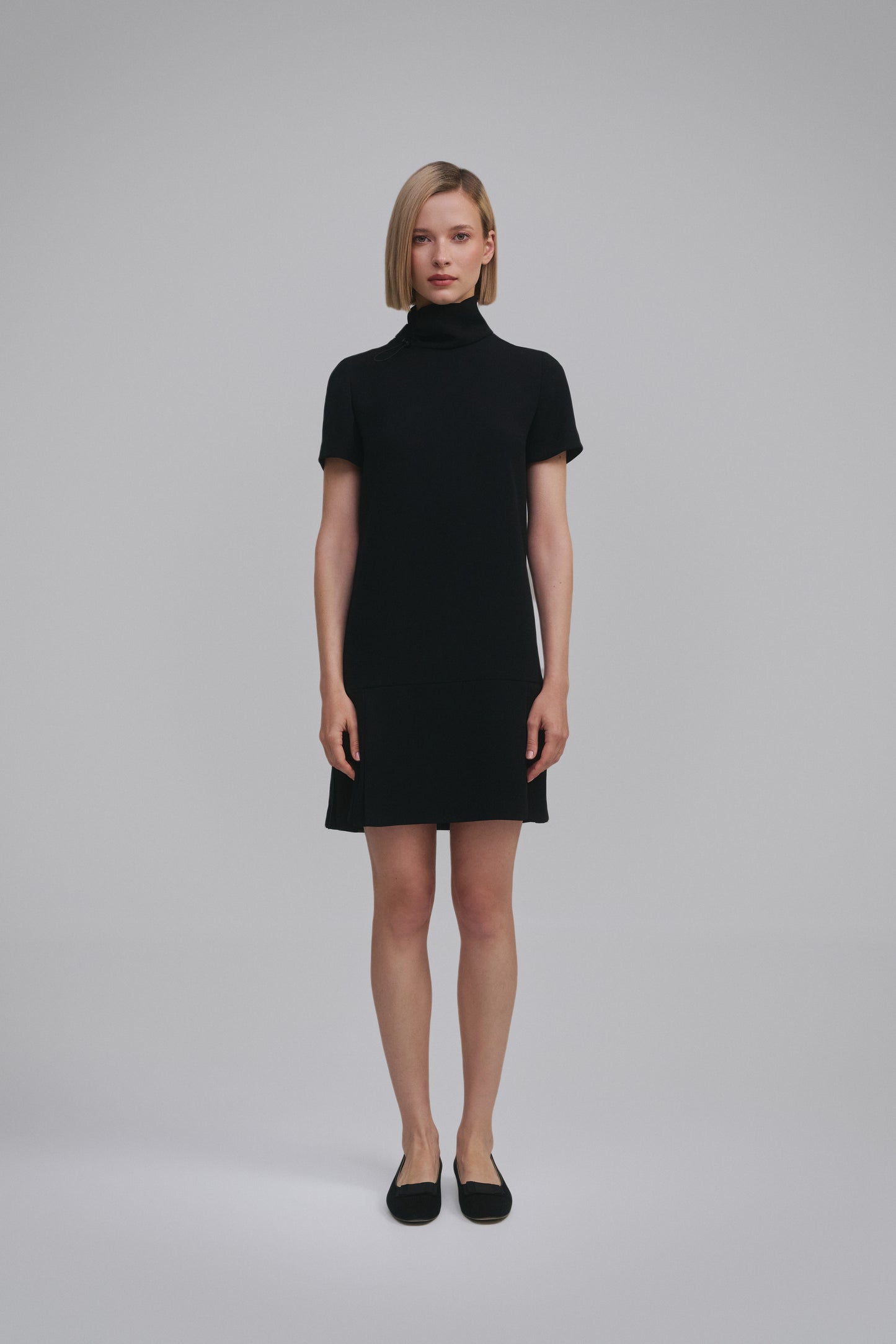 Model wears the Amelia Toro Short-Sleeve Pleated Chiffon Mini Dress in Black, front view